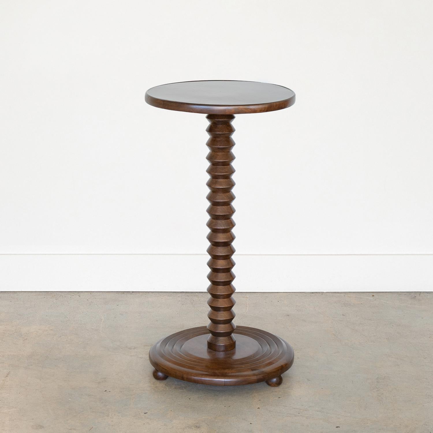 Beautiful carved wood table by Charles Dudouyt, made in France, 1940's. Thick carved oak stem with circular top and three wood ball feet on circular base. Newly refinished dark oak stain.
