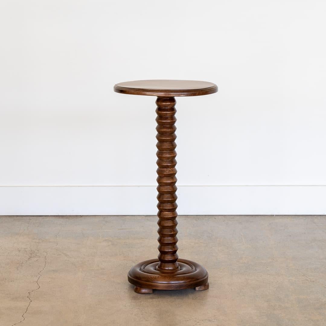 Beautiful carved oak table by Charles Dudouyt, made in France, 1940's. Thick bobbin wood stem with circular top and three wood ball feet on circular base. Newly refinished medium oak stain.
