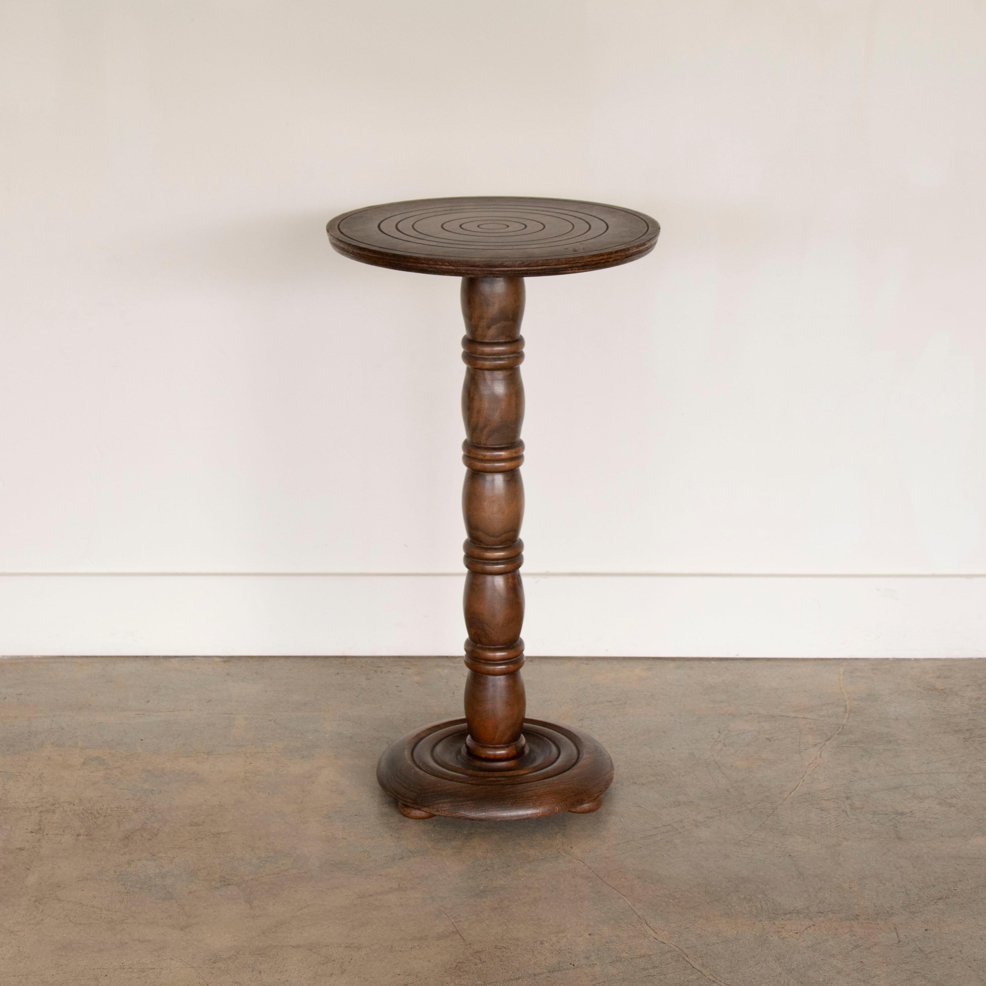 Beautiful carved oak table by Charles Dudouyt, made in France, 1940's. Carved wood stem with circular top and three wood ball feet on circular base. Original finish shows great age and patina. 