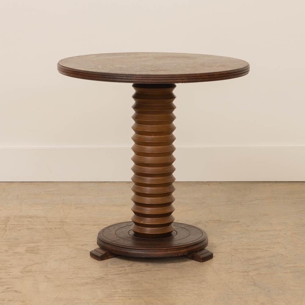 Great carved wood table by Charles Dudouyt from France, 1940's. Thick carved wood stem with circular top and base. Base has etched ring detail and rests on three carved feet. Original wood finish shows nice age and patina. Beautiful statement piece. 