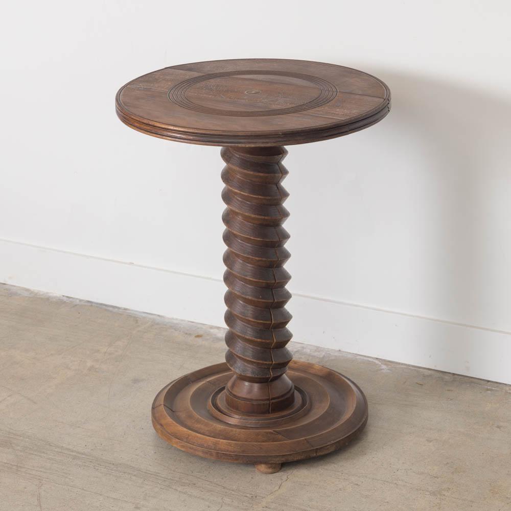 Great carved wood table by Charles Dudouyt, made in France, 1940s. Thick carved wood stem with circular top and base. Base has etched ring detail and rests on three rounded feet. Original wood finish shows great age and patina. Perfect between two