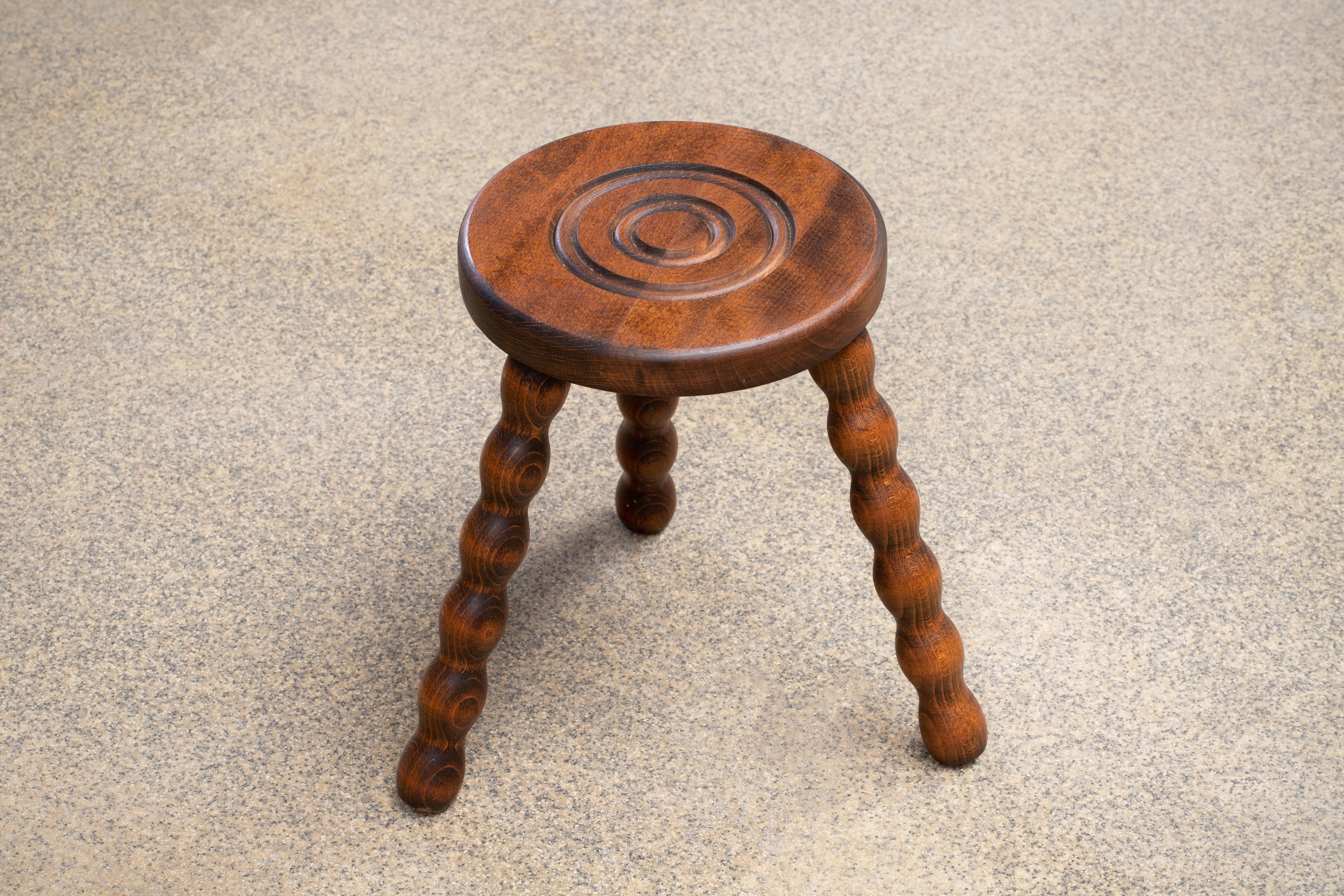 Vintage wood stool with beautiful wavy wood legs from France. Circular seat with unique carved ring detail on top. Original wood finish with great age markings and patina. Can be used as small stool or as side table next to chairs.
 