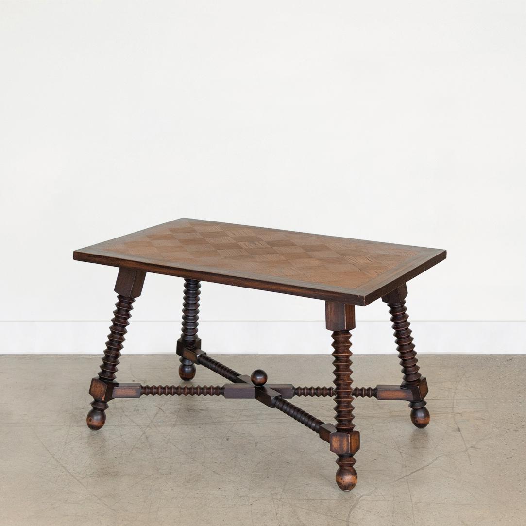 Beautiful carved wood table by Charles Dudouyt, made in France, 1940's. Rectangular top with beautiful oak wood veneer parquet design. Solid oak wood frame with four carved wood legs and ball feet. Original dark wood finish shows nice age markings
