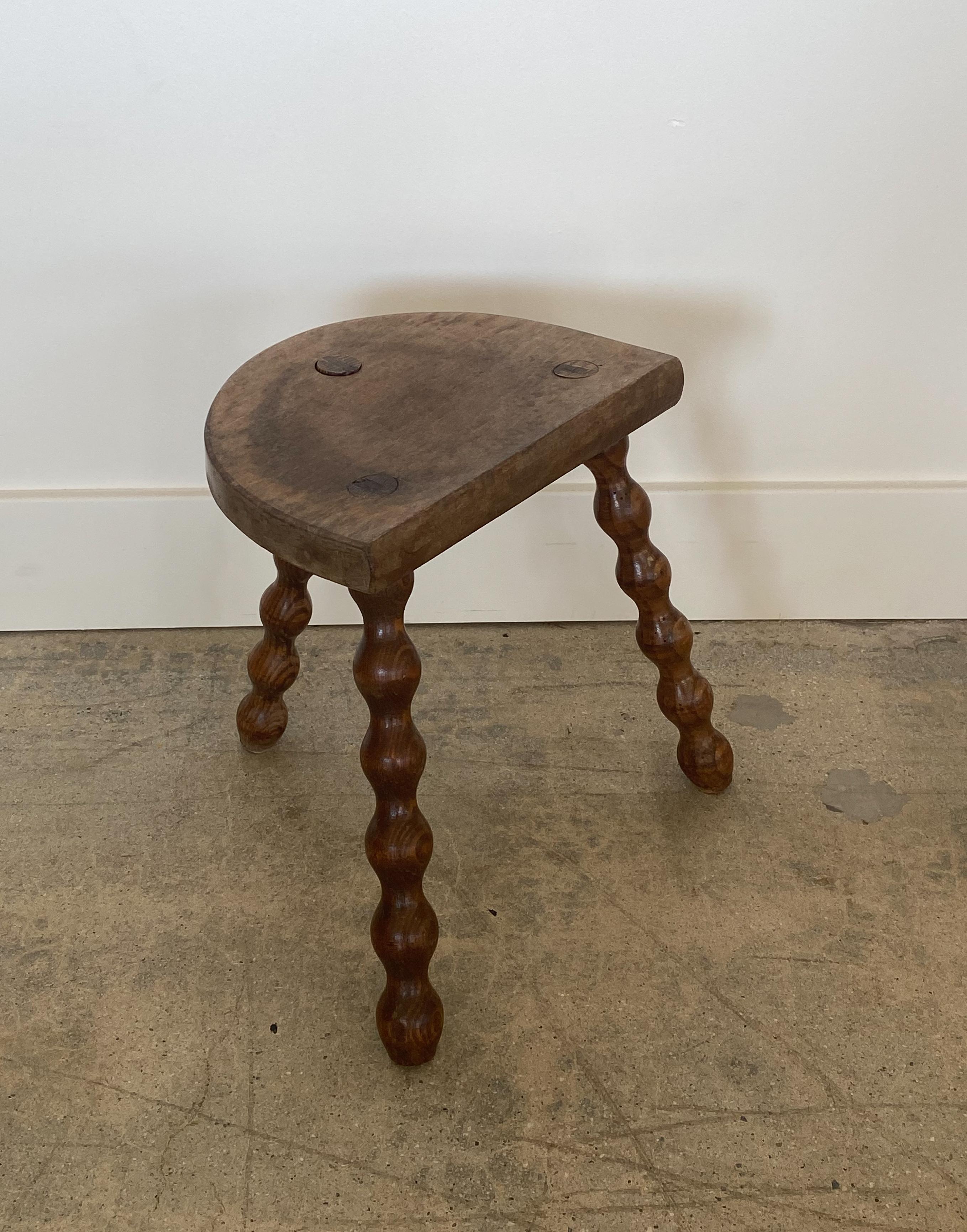 Vintage wood stool with beautiful wavy turned legs and semicircle seat from France. Original wood finish with great age markings and patina. Can be used as a small stool or as a side table.


 