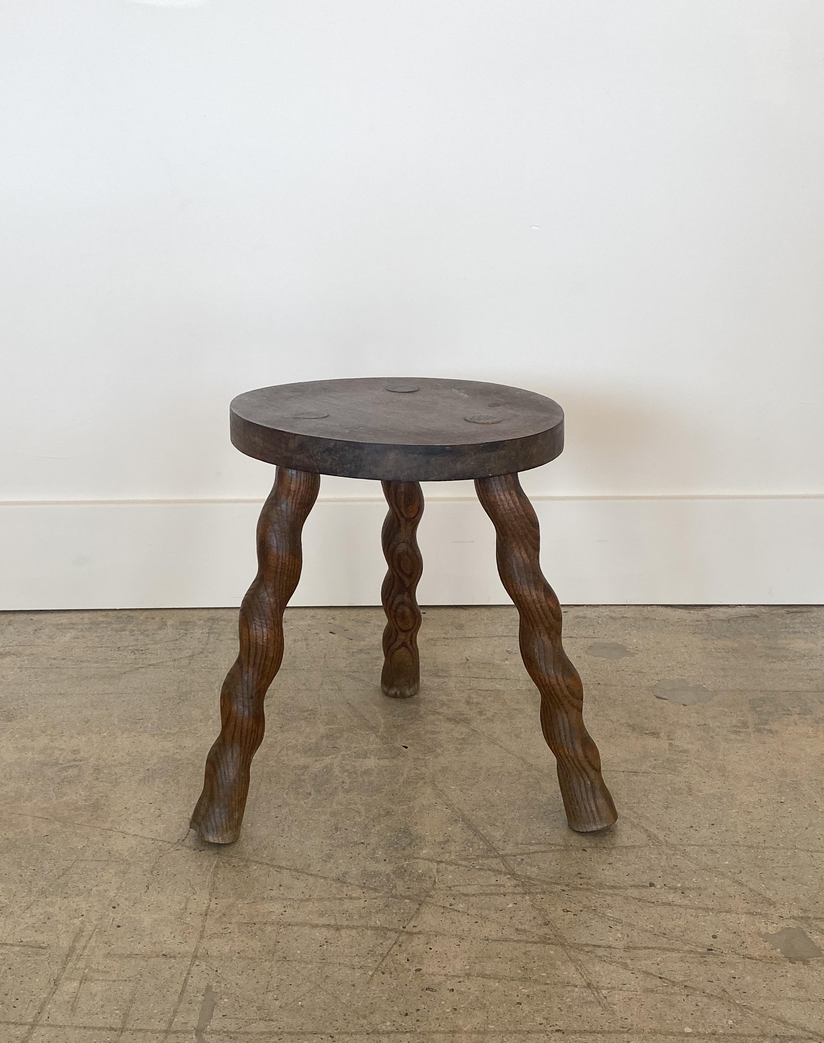 Vintage French wood stool with beautiful wavy twisted legs and circular seat. Original wood finish with great age markings and patina. Can be used as a small stool or as a side table.


 