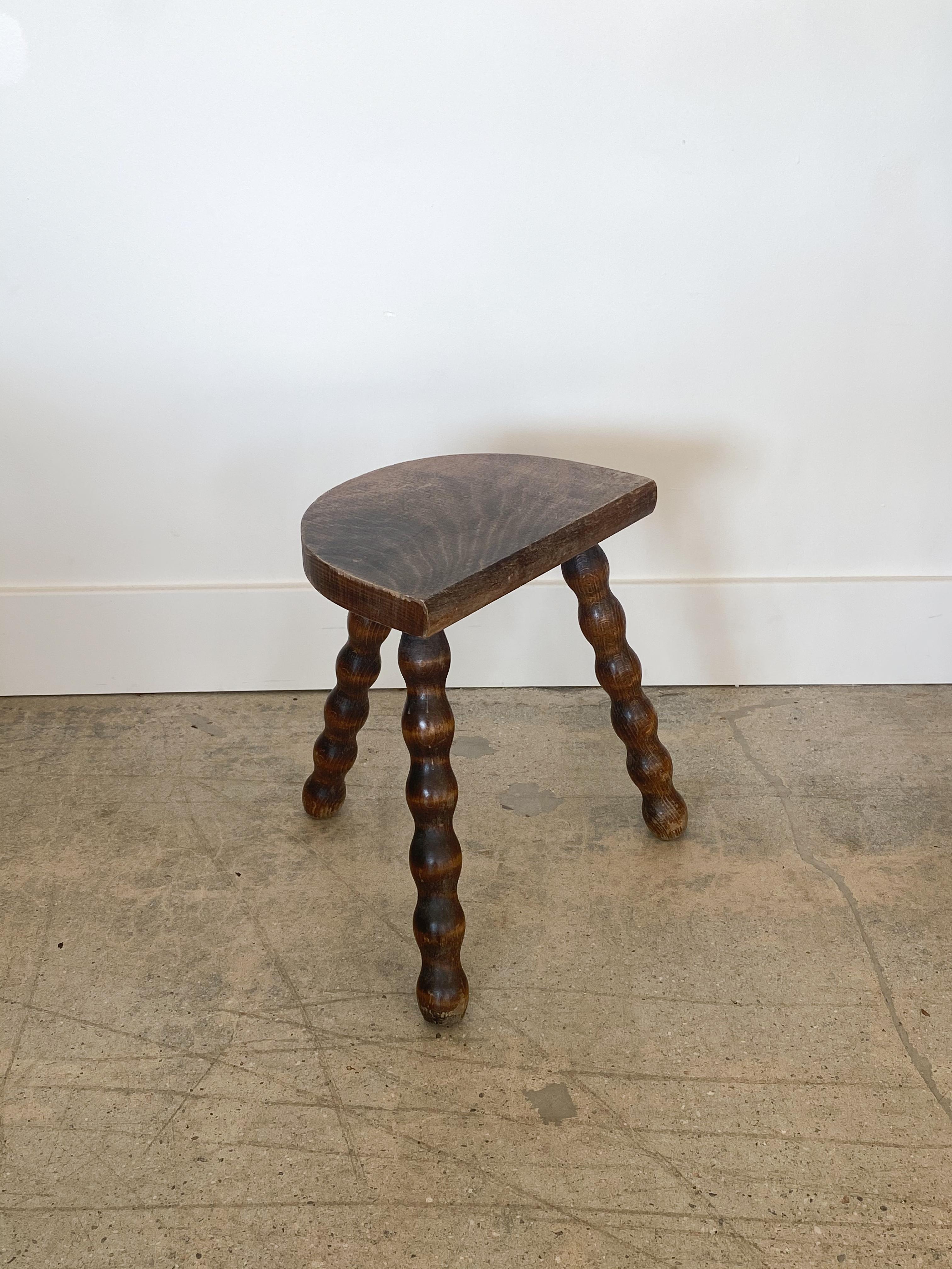 Vintage wood stool with beautiful wavy turned legs and semicircle seat from France. Original wood finish with great age markings and patina. Can be used as a small stool or as a side table.


 