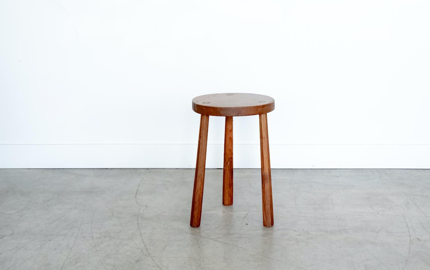 Vintage circular wood stool with tripod legs from France. Original light wood finish with great age markings and patina. Can be used as a stool or as side table next to chairs. 

 