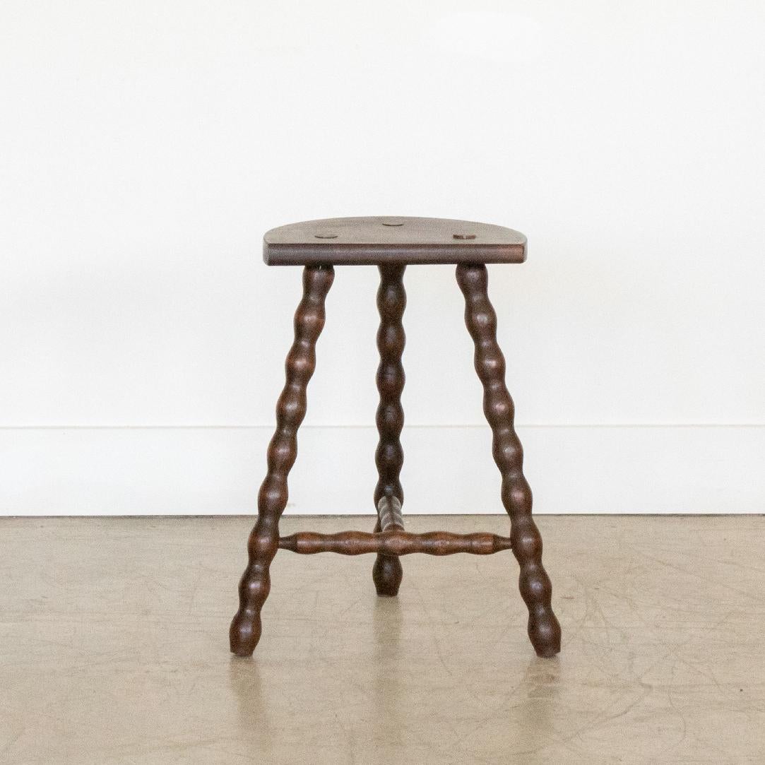 Vintage tall wood stool with semi-circle seat and wavy tripod legs from France. Original wood finish with great age markings and patina. Can be used as a stool or as side table. 



 
