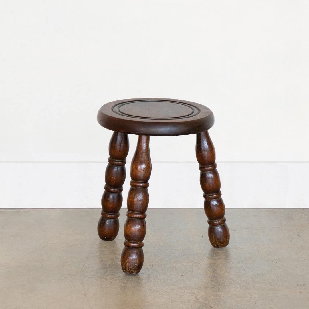 Vintage short wood stool with beautiful chunky carved wood legs from France. Circular seat with carved ring detail on top. Original wood finish with great age markings and patina. Can be used as stool or as side table next to chairs. 

