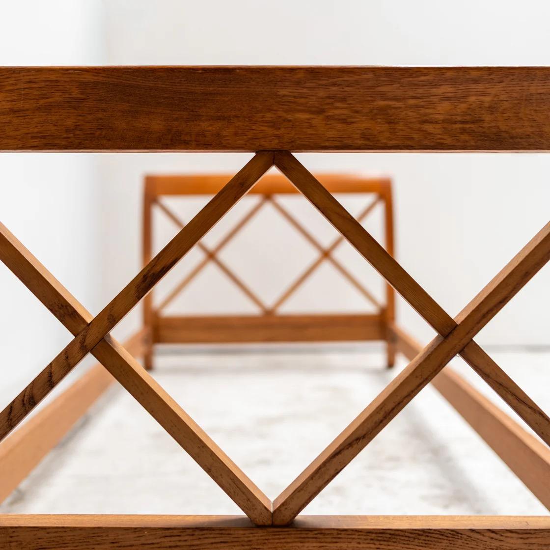 Elegante struttura letto in legno con pannelli di testa e piedi a reticolo incrociato che ricordano il modernismo scultoreo di Jean Royère. La solida struttura mostra una raffinata falegnameria e una calda patina.