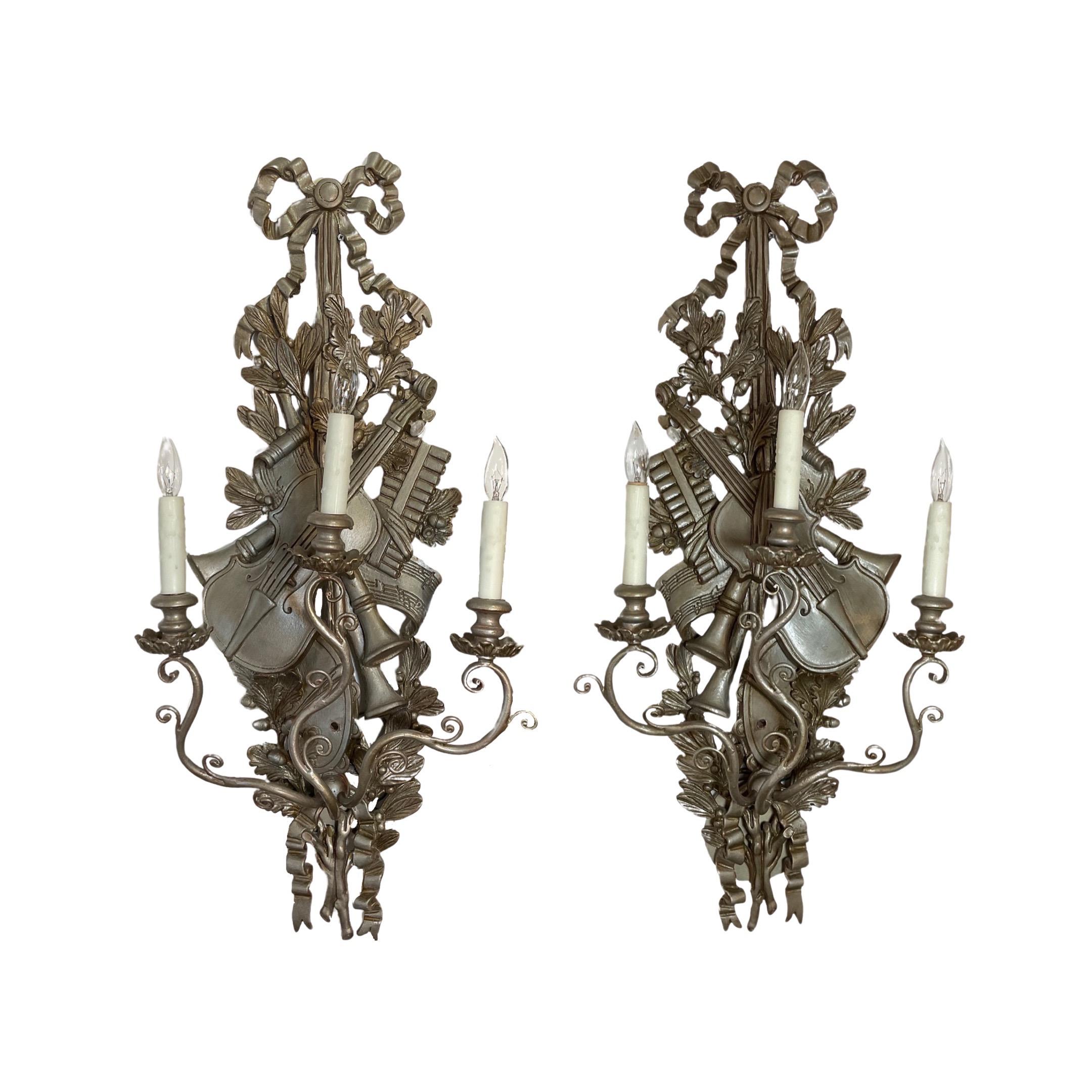 This is a stunning pair of French wall sconces, from 1840s, hand-crafted from wood and finished with a luxurious gold-leaf veneer. Combining enduring craftsmanship with an elegant aesthetic, these sconces will make a timeless statement in any space.