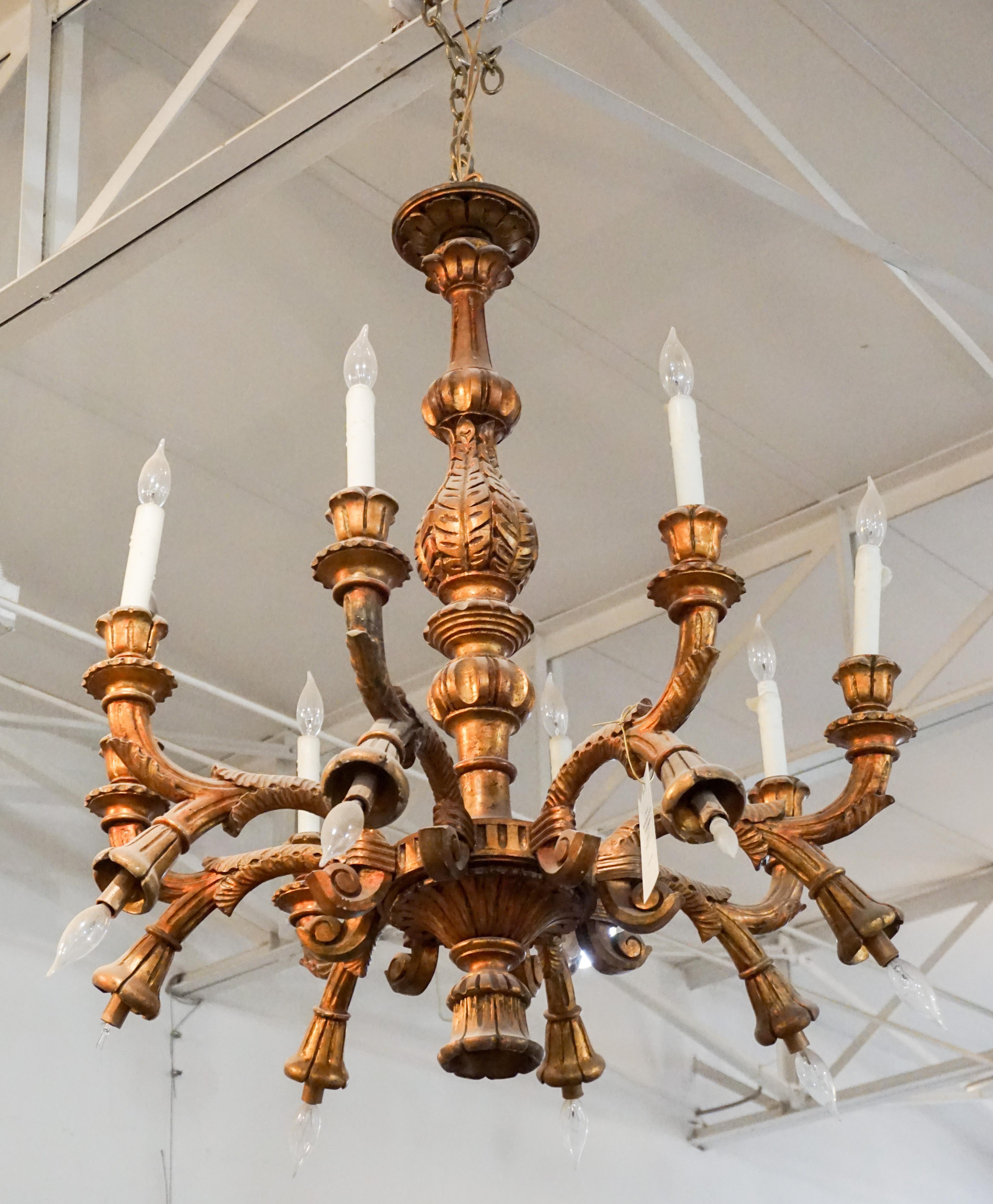This antique wooden chandelier features eight arms and beautiful carvings. Wired and ready for install, originates from France, circa 1900.

Measurements: 34'' W x 40'' H.