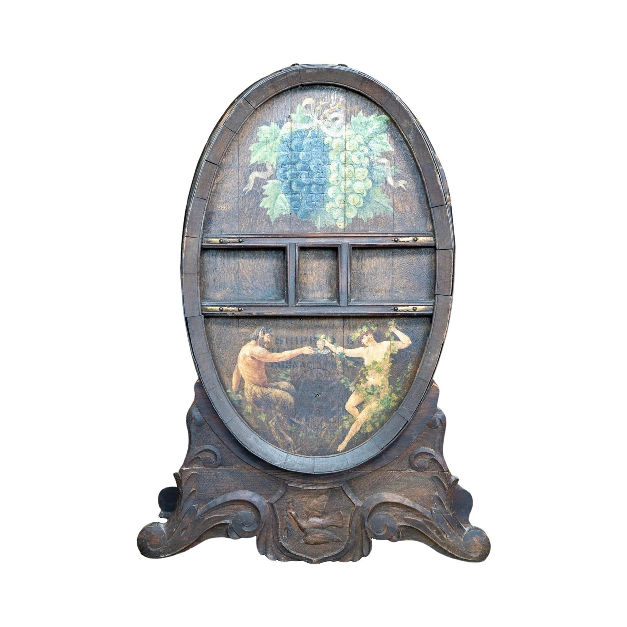 This French Wooden Cognac Barrel is a unique and ornamental piece perfect for any liquor enthusiast. Made from high-quality wood, it features a decorative mural of grapes and a festive scene of a Satyr and a Maenad. The fitted stand can be separated