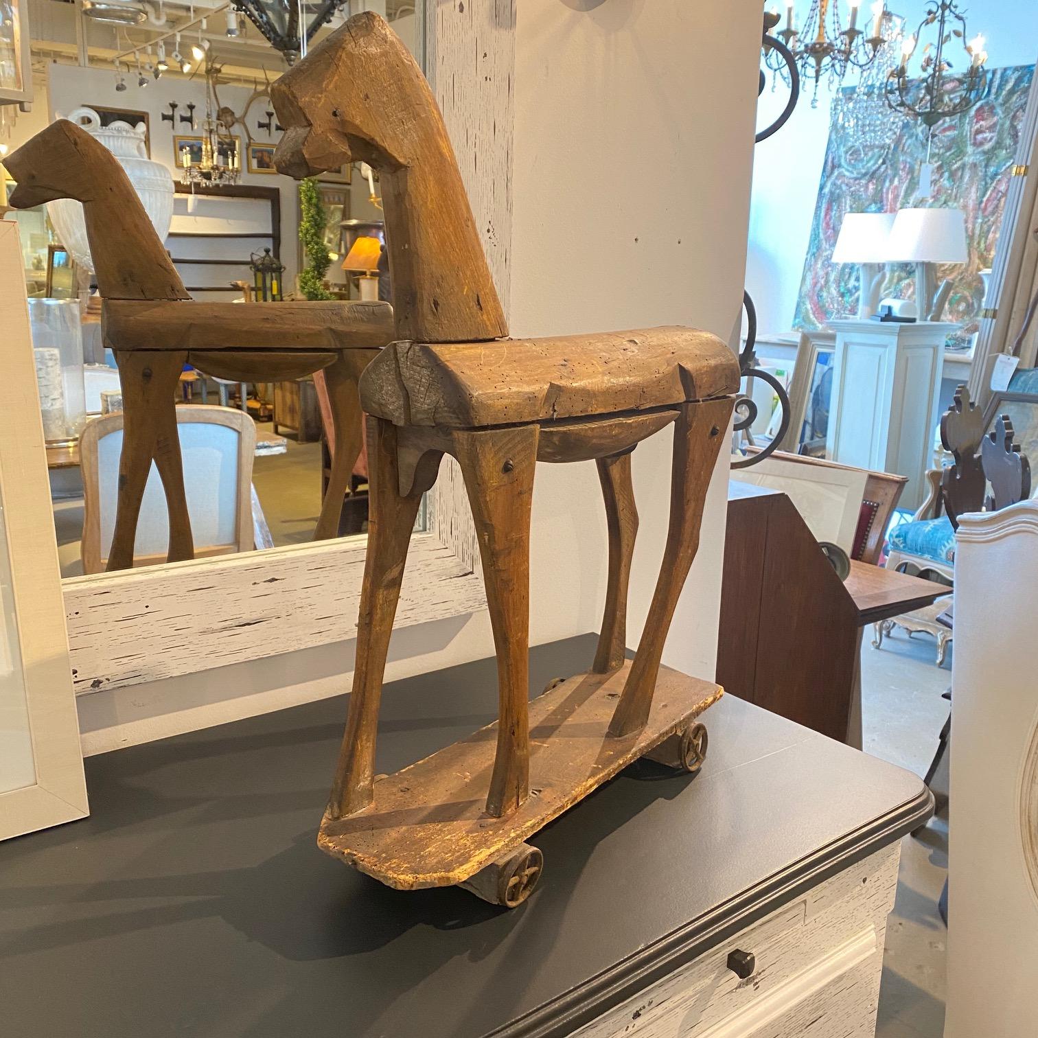 Early 19th century, French wooden horse toy on wheels.