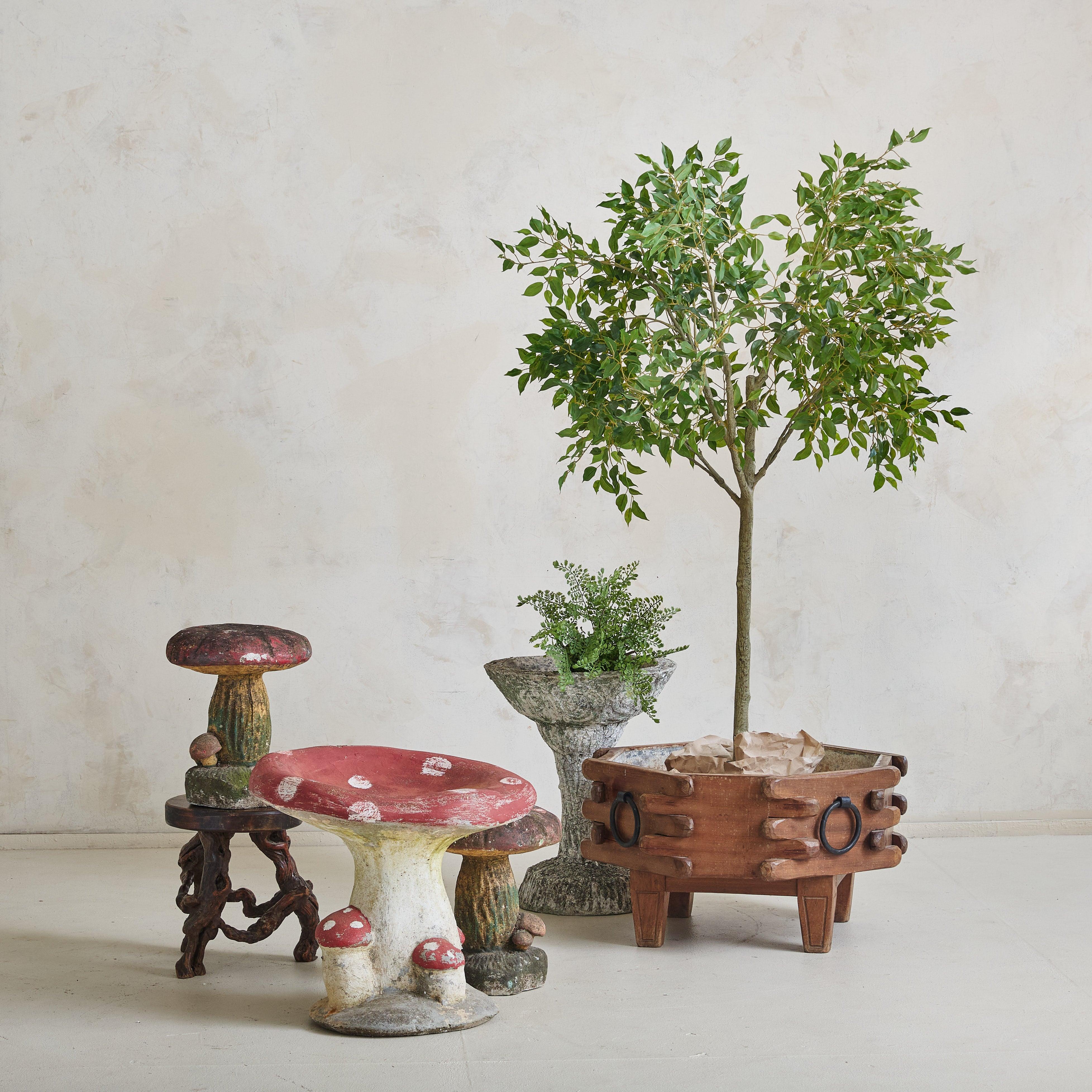 A 1960s French wooden planter, echoing the style of Guillerme et Chambron. Crafted from solid wood, the planter's octagonal form is accentuated by the interplay of carved notches along the sides. The aged patina hints at its history, while the
