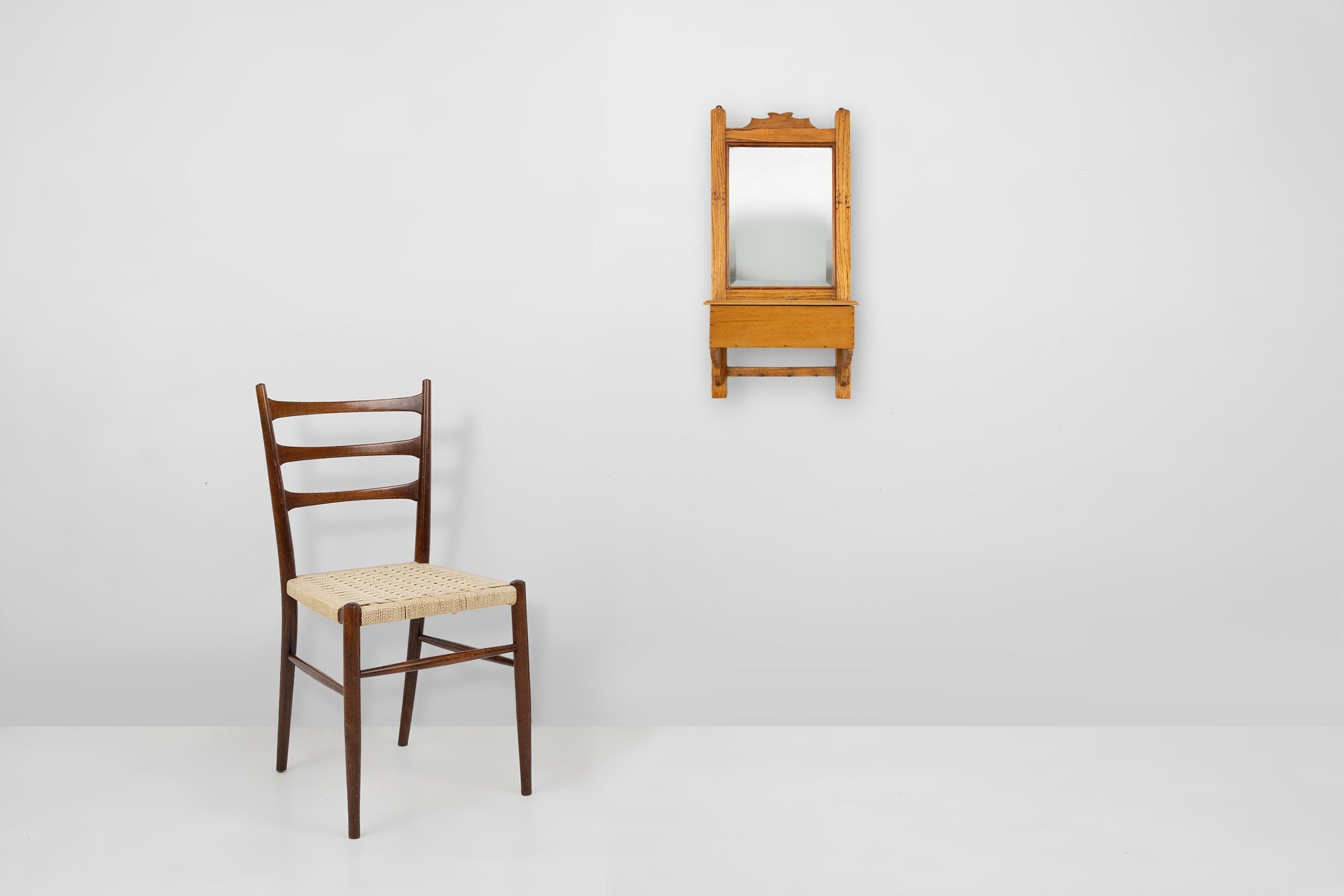 France / 1900 / shaving cabinet / wood, mirror / rustic / mid century

A beautifully carved wooden frame with a mirror and a wooden container with wooden cover underneath. At the bottom four small hooks. Crafted around 1900 in France.

A stylish