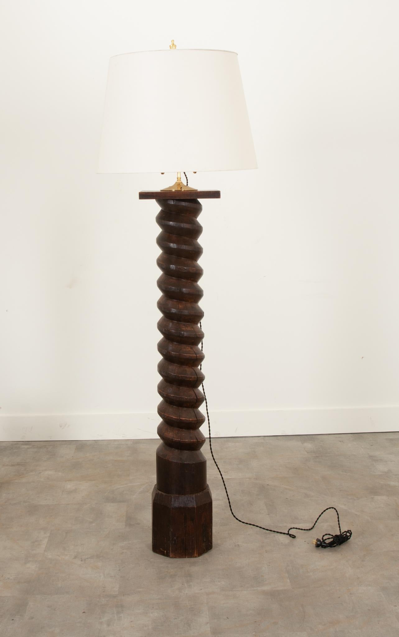 This wonderfully aged 19th century grape press screw from a winery in Burgundy, France has been converted into a stunning floor lamp. The shaft would have driven a large stone wheel downward, crushing and squeezing grapes, forcing out their juice as