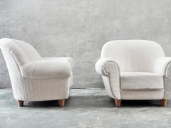Travail français, paire de fauteuils enveloppants en laine d'agneau et noyer, vers 1935.
