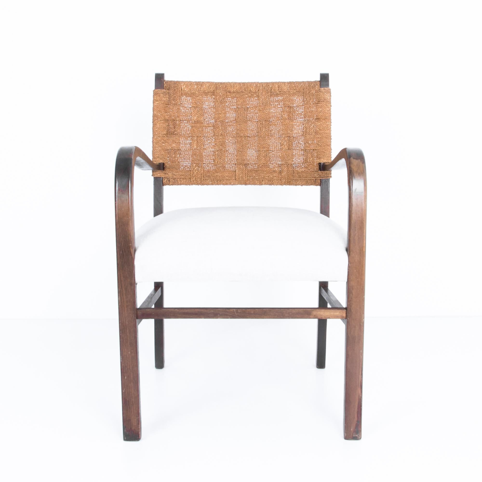 A Classic Mid-Century Modern design from France, circa 1940. A simple and elegant geometry contrasts the soft and comfortable seat with geometric bentwood element and woven cord back. The use of natural materials and neutral colours is a subtle nod