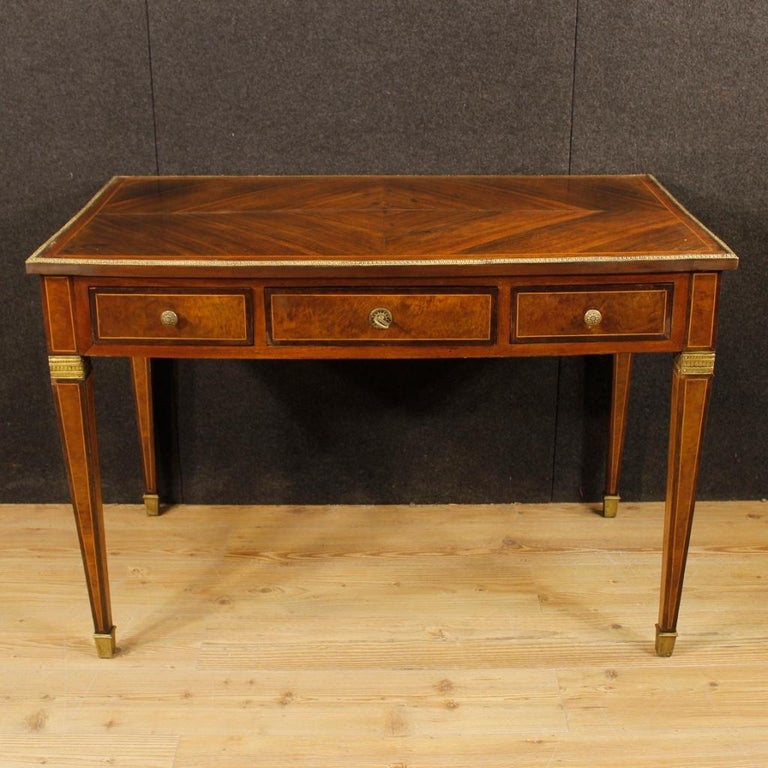 French writing desk in Louis XVI style from the mid-20th century. Furniture finished from centre with three drawers of good service. Table inlaid in walnut, mahogany, palisander, maple, burl and fruitwood. Writing table ideal for a salon or