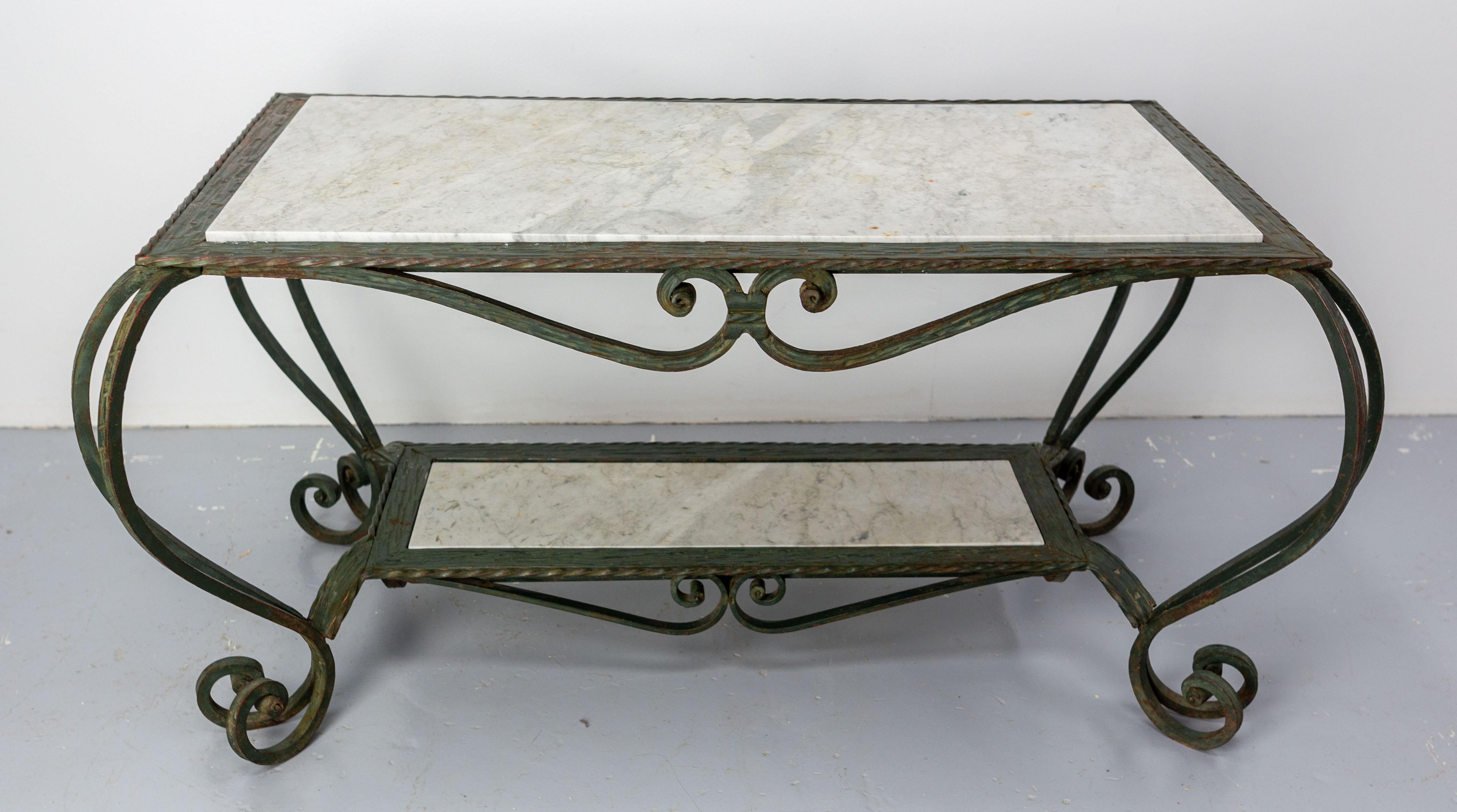 French midcentury coffee table with a marble top and a marble shelf below the top.
Very nice iron work especially for the parts surrounding the marble plates which gives a textured appearance.

In good condition 

Shipping:
 59 / 103 / 48 cm