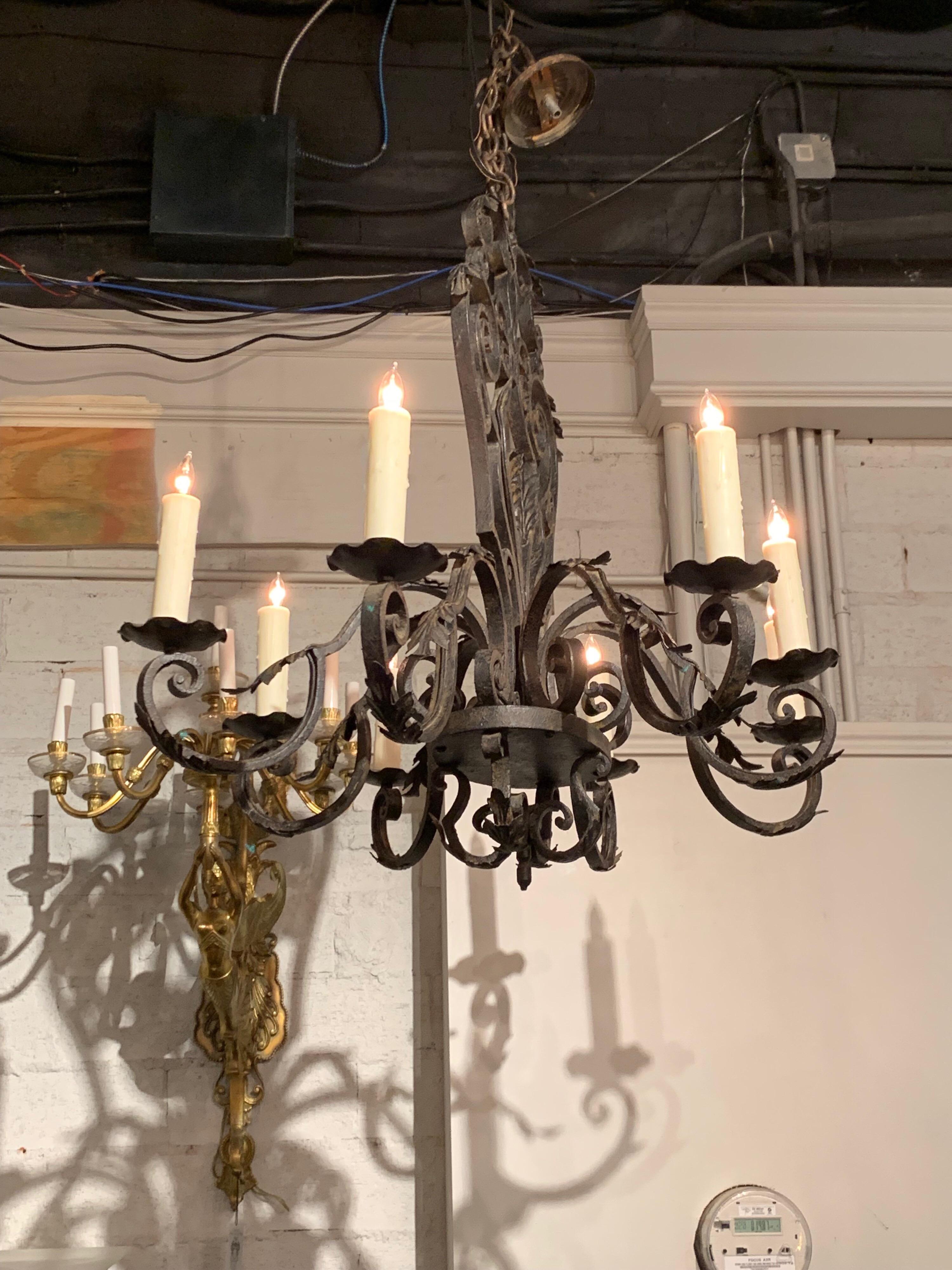 Beautiful French 8-light wrought iron chandelier. Nice heavy scroll work design on the wrought iron. Comes with a decorative chain and canopy, ready to hang.