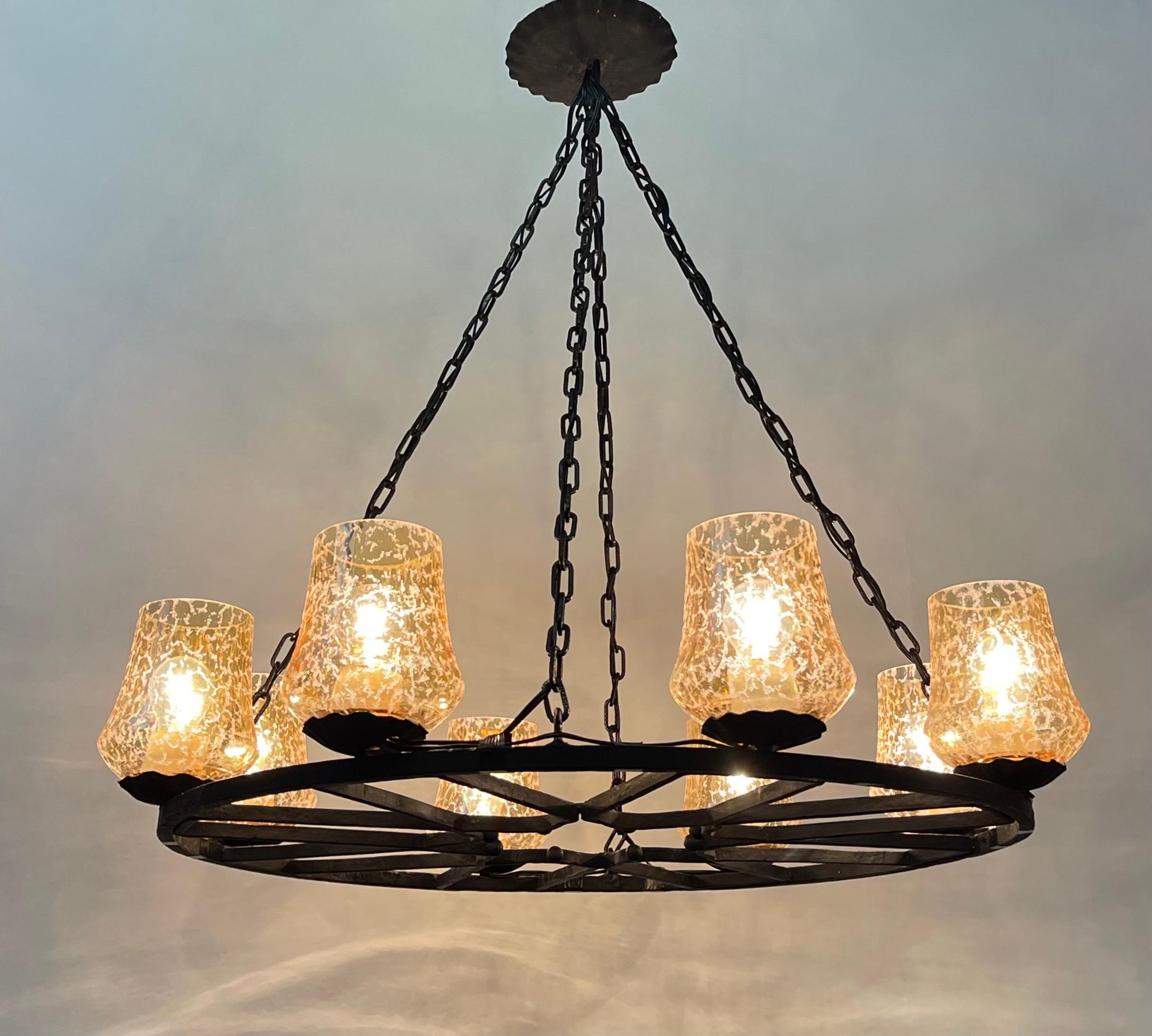 A large wrought iron and amber glass chandelier, France, circa 1950s.
Socket: 8 x e27 (Edison) for standard screw bulbs.


