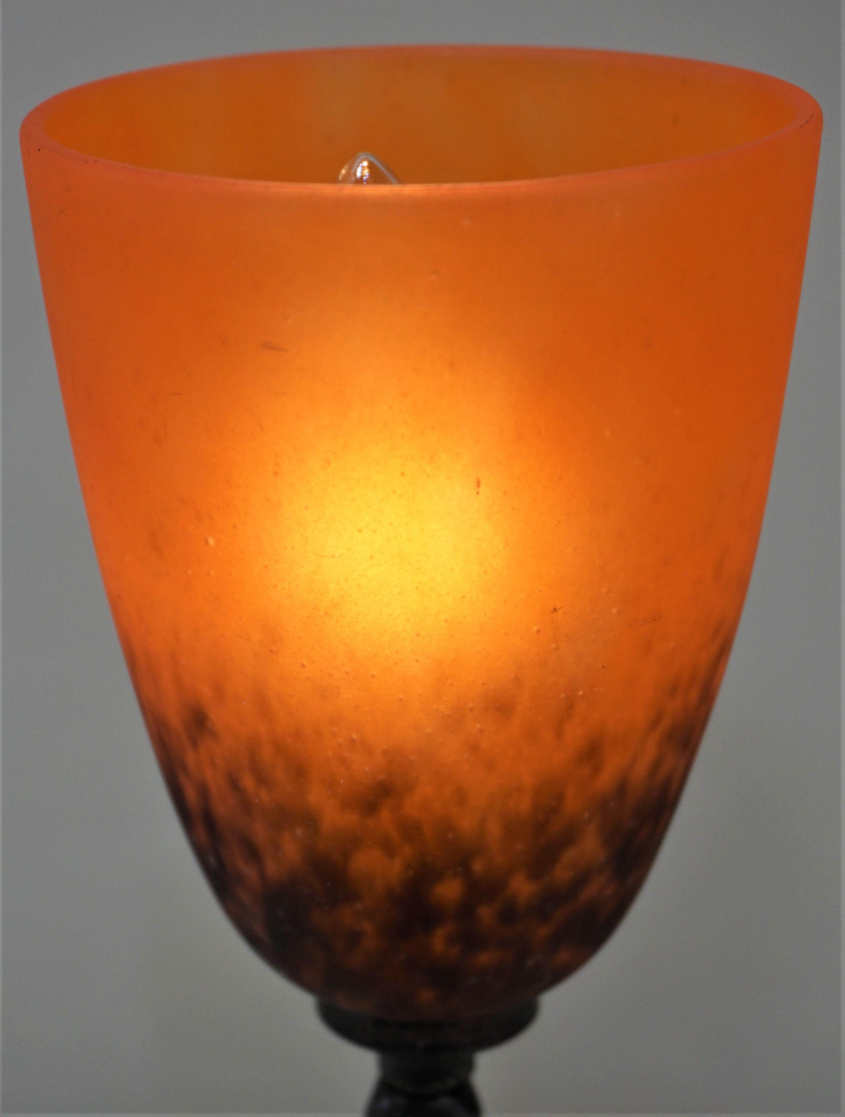 Wrought iron black or brown to orange red blown glass table lamp.