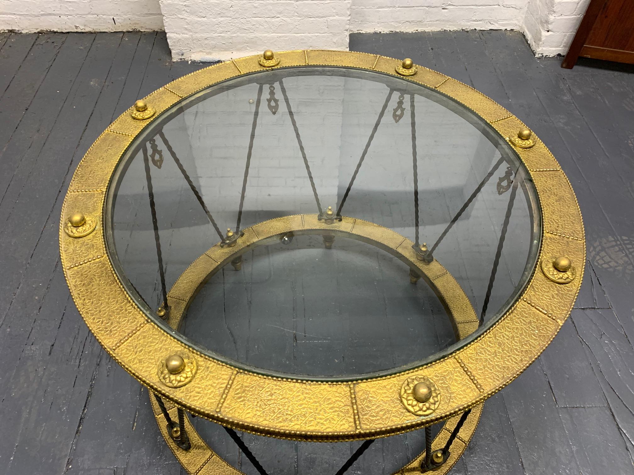 French wrought iron and brass side table. Very decorative and unique brass side table with dangling tassels, and a twisted wrought iron frame.
