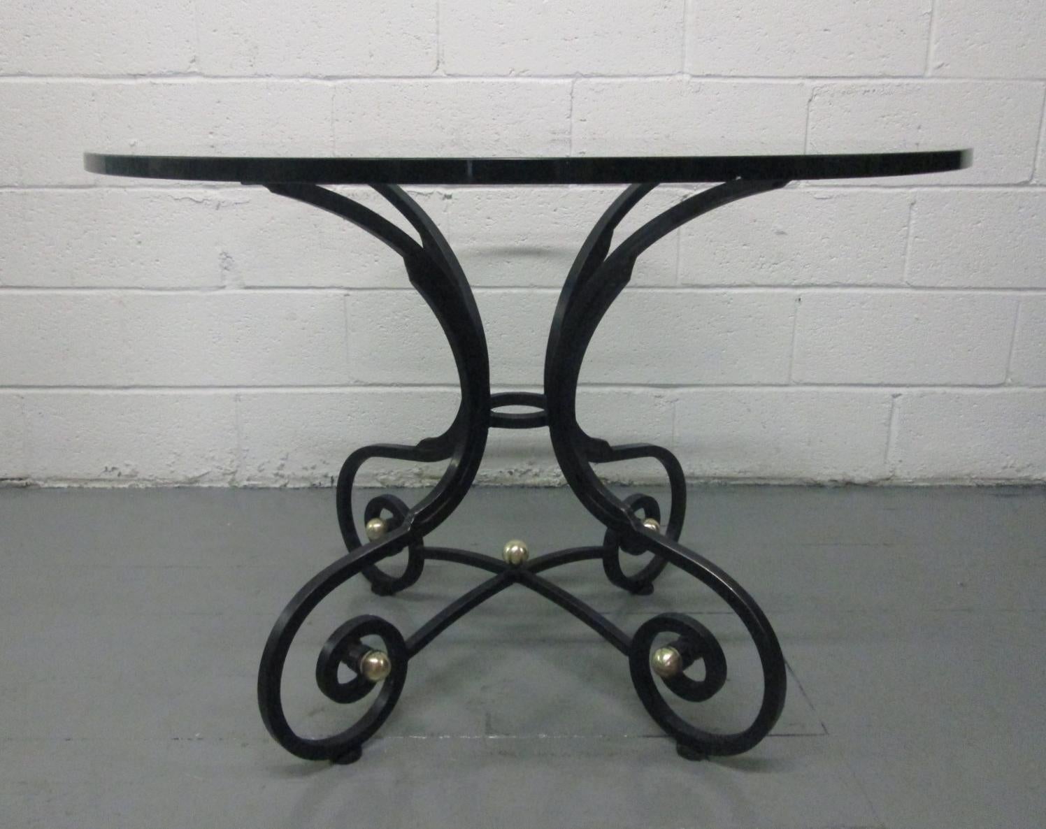 French wrought iron and bronze table or gueridon. The table has bronze round accents and can be used indoor or outdoors.
Would also make a nice dining, center table or occasional table.