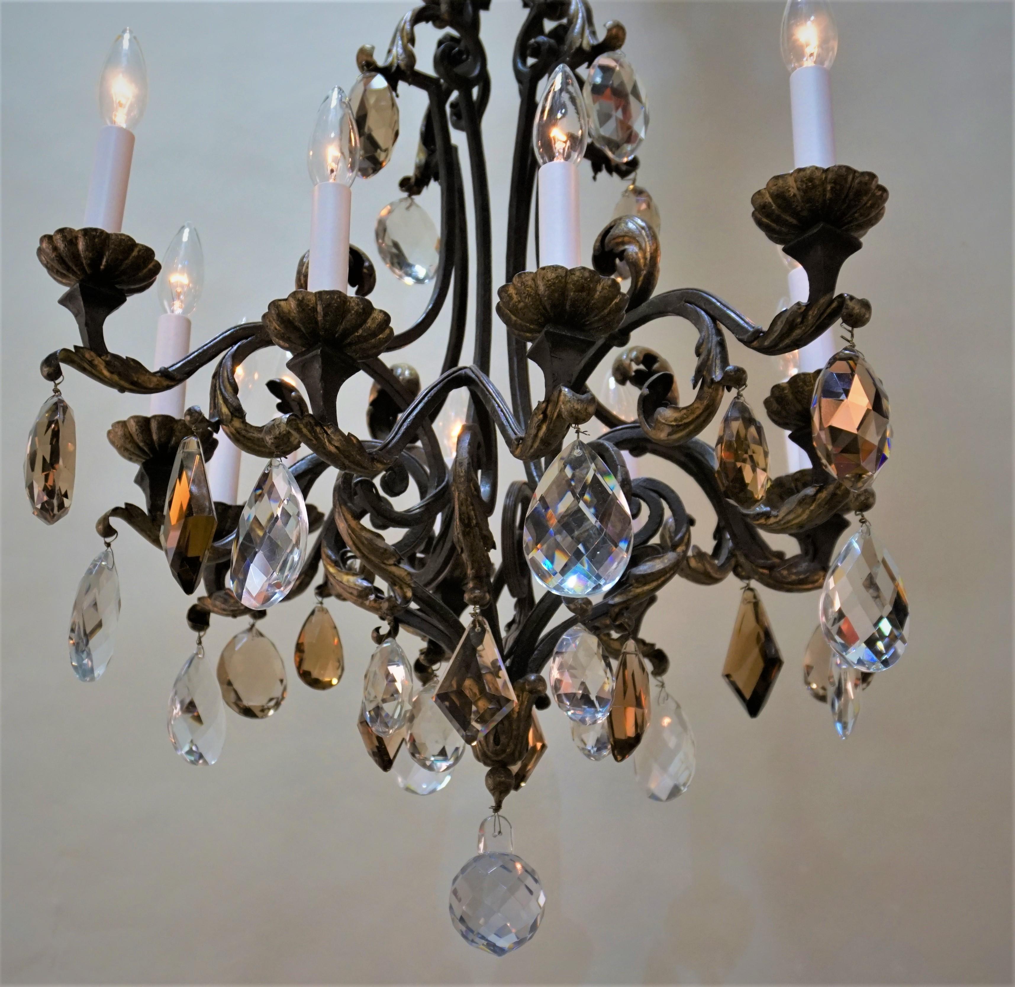 Elegant French wrought iron with some gilt decoration and crystal chandelier.
Measures: Total height is 55'with all the chain, minimum height fully installed 36