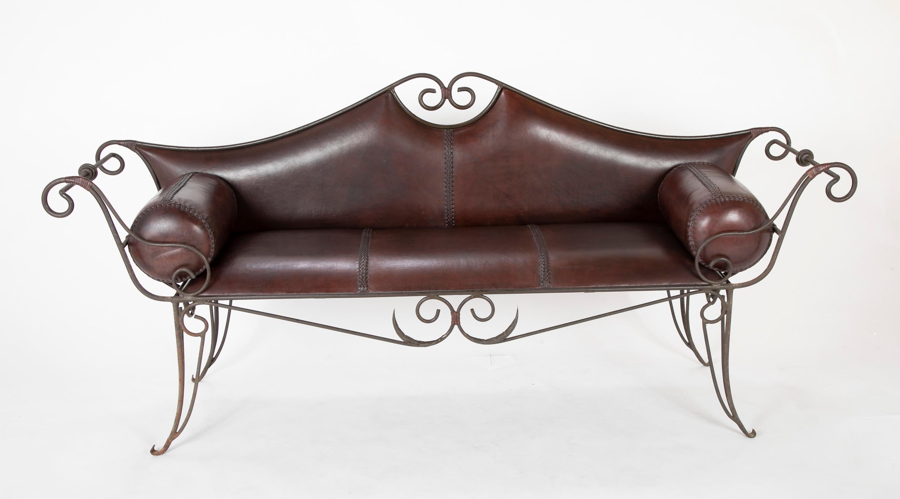 French baroque style iron and leather settee circa 1970's. Very handsome and elegant hand crafted wrought iron and leather sofa or settee. Some pieces of furniture just make you smile, this is one. The craftsmanship of the iron work is superb, the