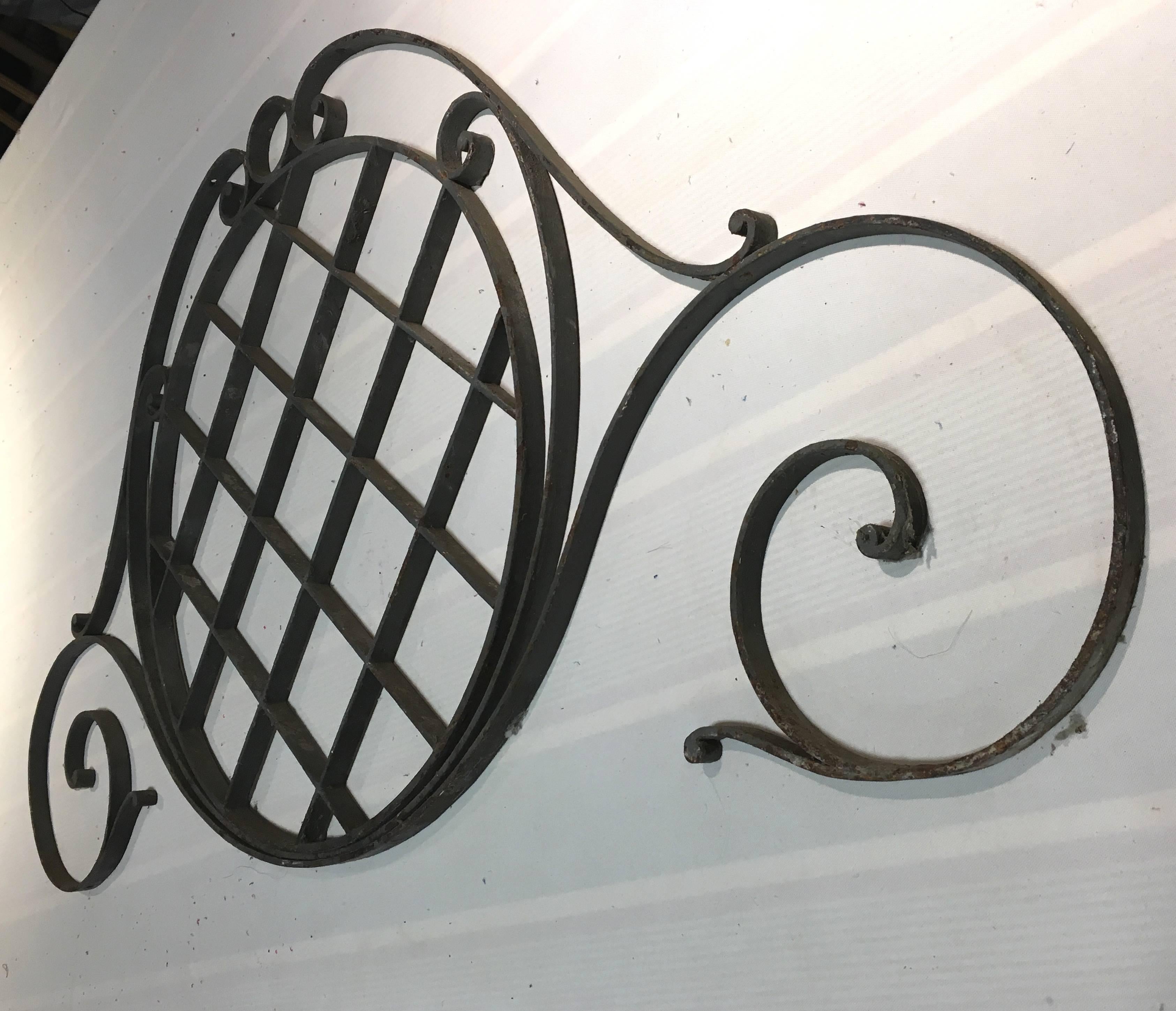 A late 19th century French architectural grill in wrought iron with its original dark grey painted finish. Could be used as an iron headboard or as a crest on a mirror.