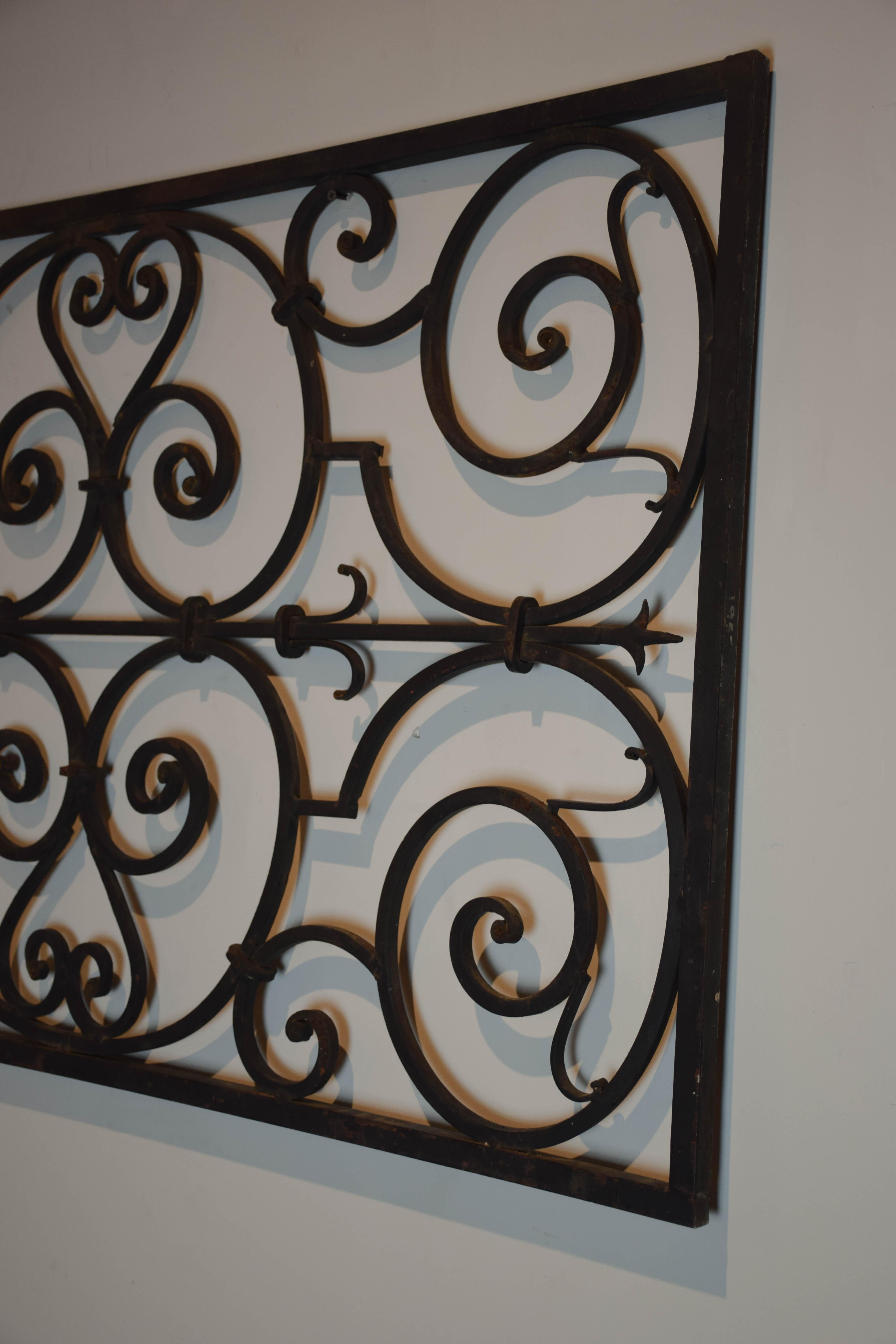 This vintage French wrought iron architectural panel is hand forged in a scroll detail. This piece will add character as a wall or garden accent.