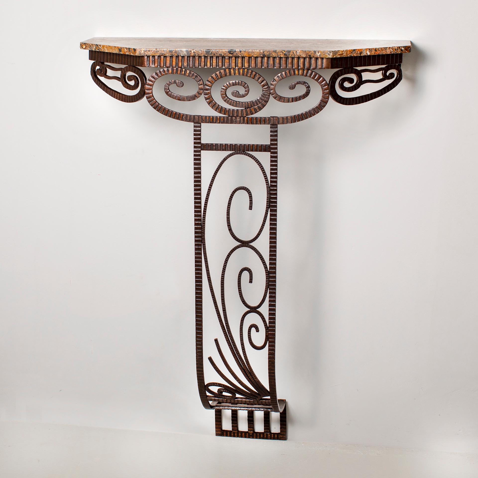 Graceful Art Deco console that captivates with its special leg design.
The object is designed with fine rods, all ribbed throughout. Sweeping, snail-like elements are located 
in the frame of the console. The central foot is straight down and runs