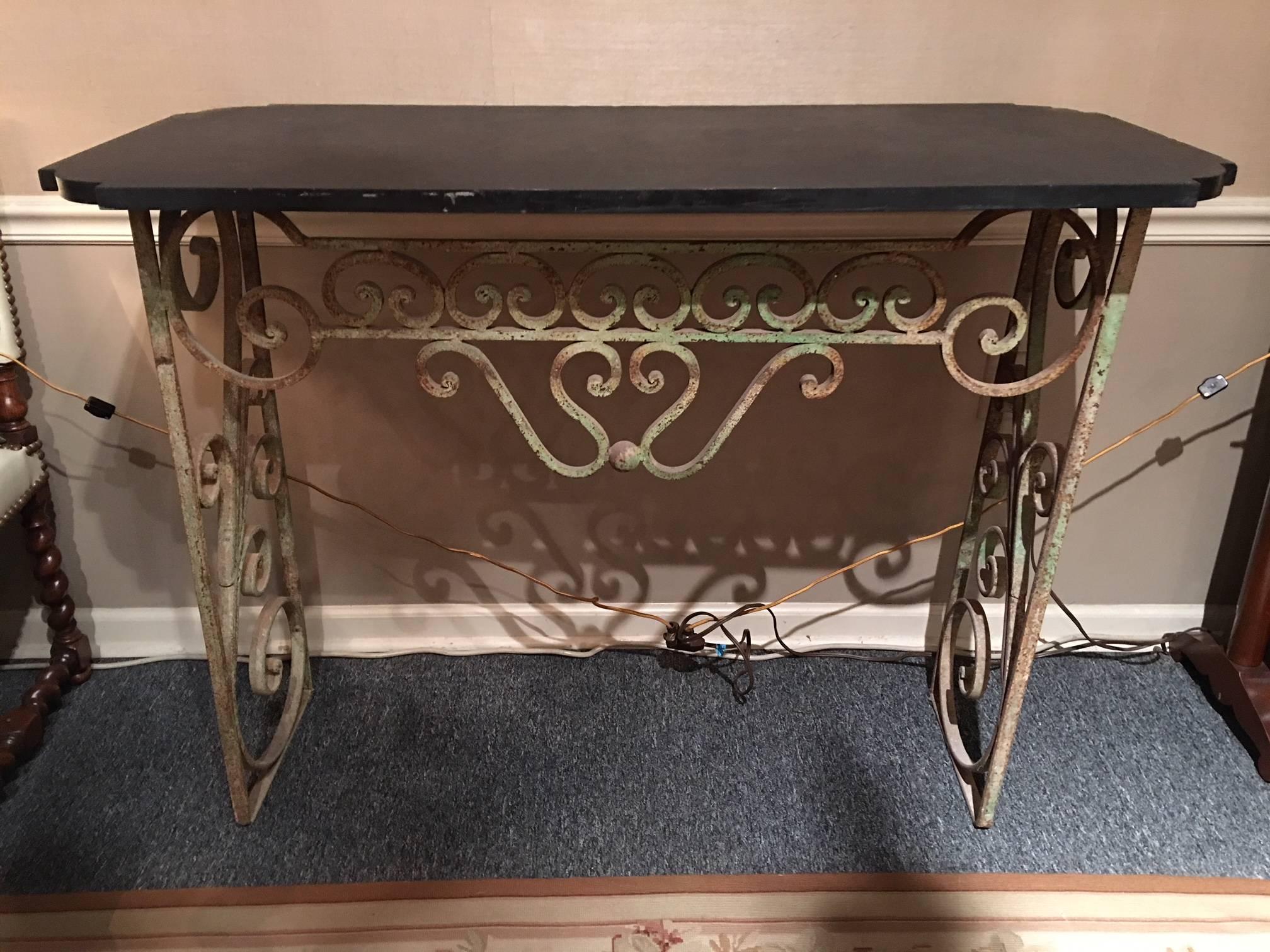 French wrought iron console with a black marble top, early 20th century.