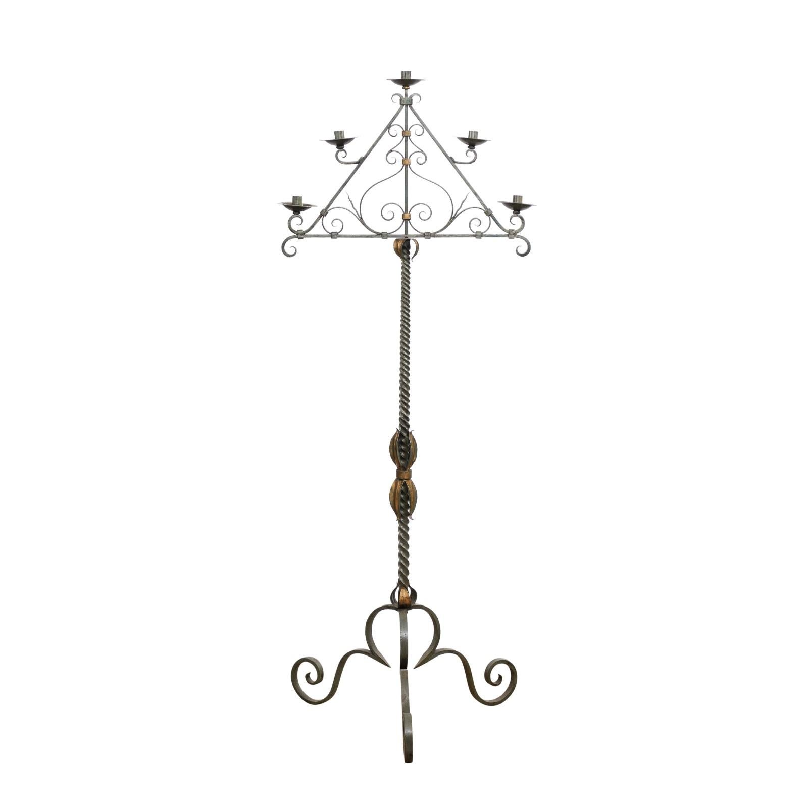 A large French wrought iron free standing candelabra from the 20th century with five arms, celadon lacquer, gilded accentuation and tripod base. Created in France during the 20th century, this large free standing candelabra features a triangular