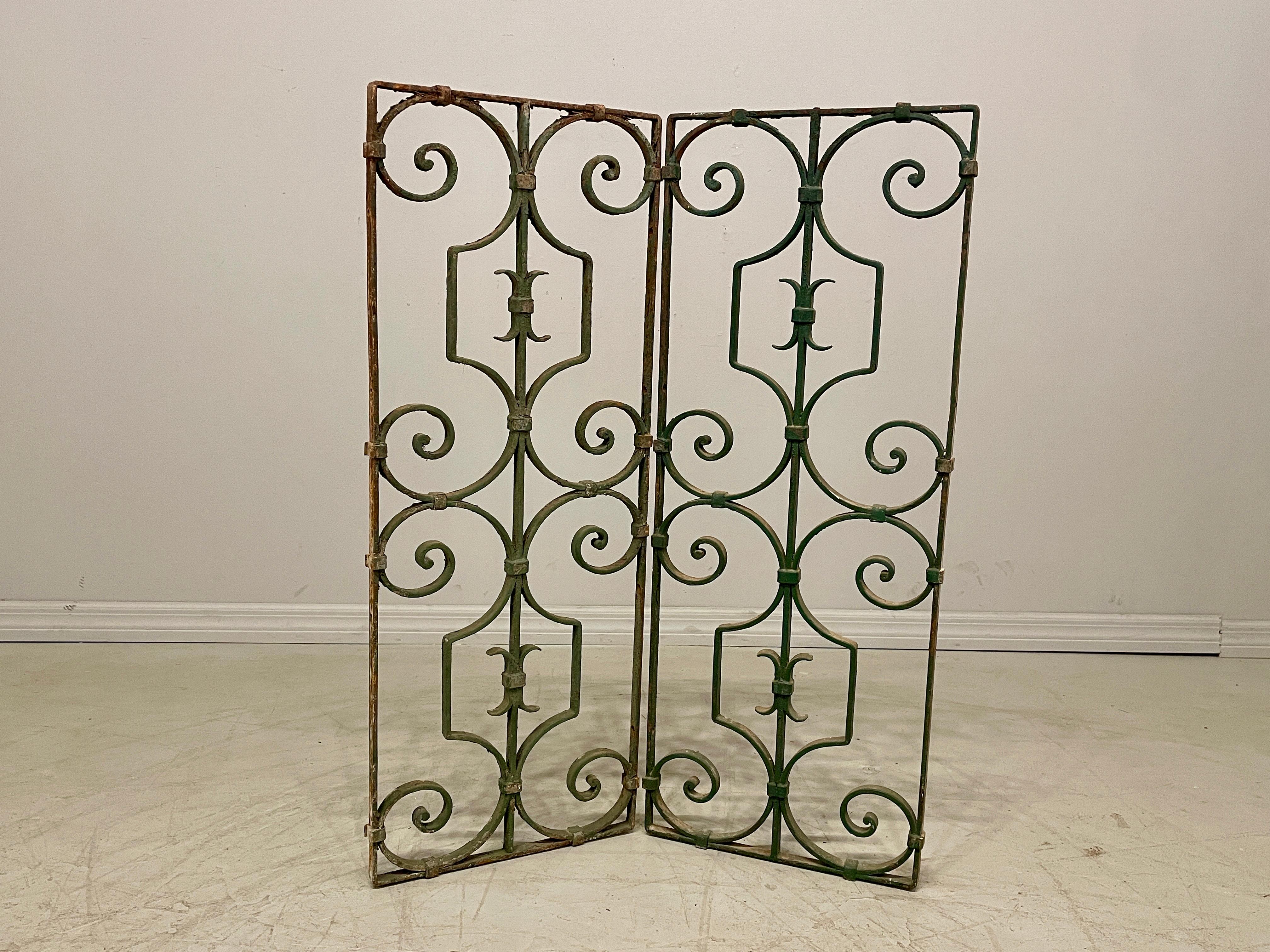 A pair of French wrought iron garden gate grilles or decorative panels with green  painted patina. Good quality iron work. Some rust and peeling paint. Please refer to photos for more details. Pictures are part of the description. Circa 1900
Overall