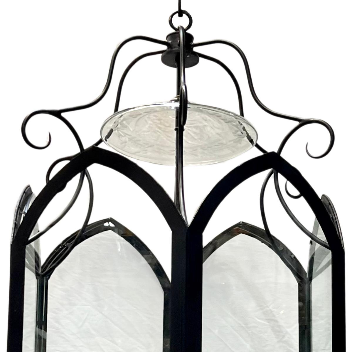 A French circa 1950's wrought iron lantern with glass insets and 6 interior candelabra lights.

Measurements:
Diameter: 25