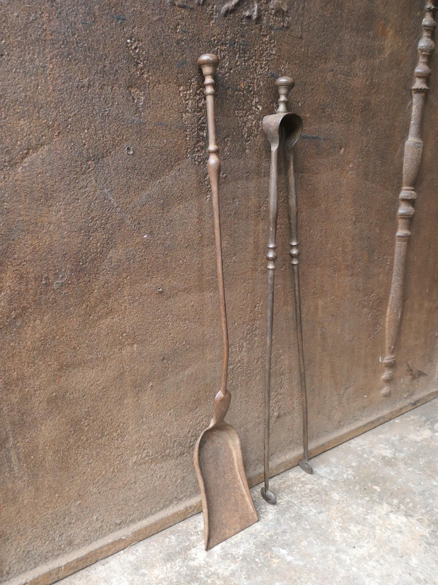 19th century French Napoleon III fireplace tools. The tool set consists of tongs and shovel. Made of wrought iron. It is in a good condition and is fully functional.