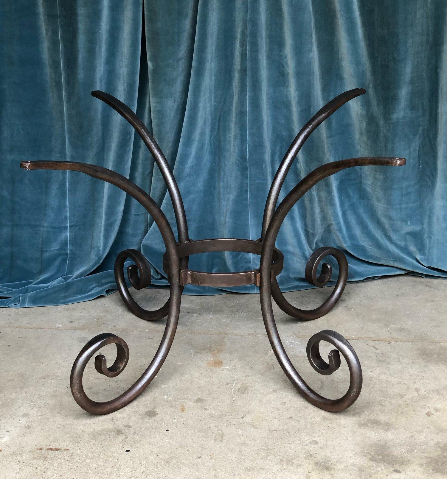 A French wrought iron oval table base from the 1970s. This oval wrought iron table base with a contemporary design is a sturdy and well-made piece of furniture. Its heavy construction makes it suitable for a large stone top, which would complement