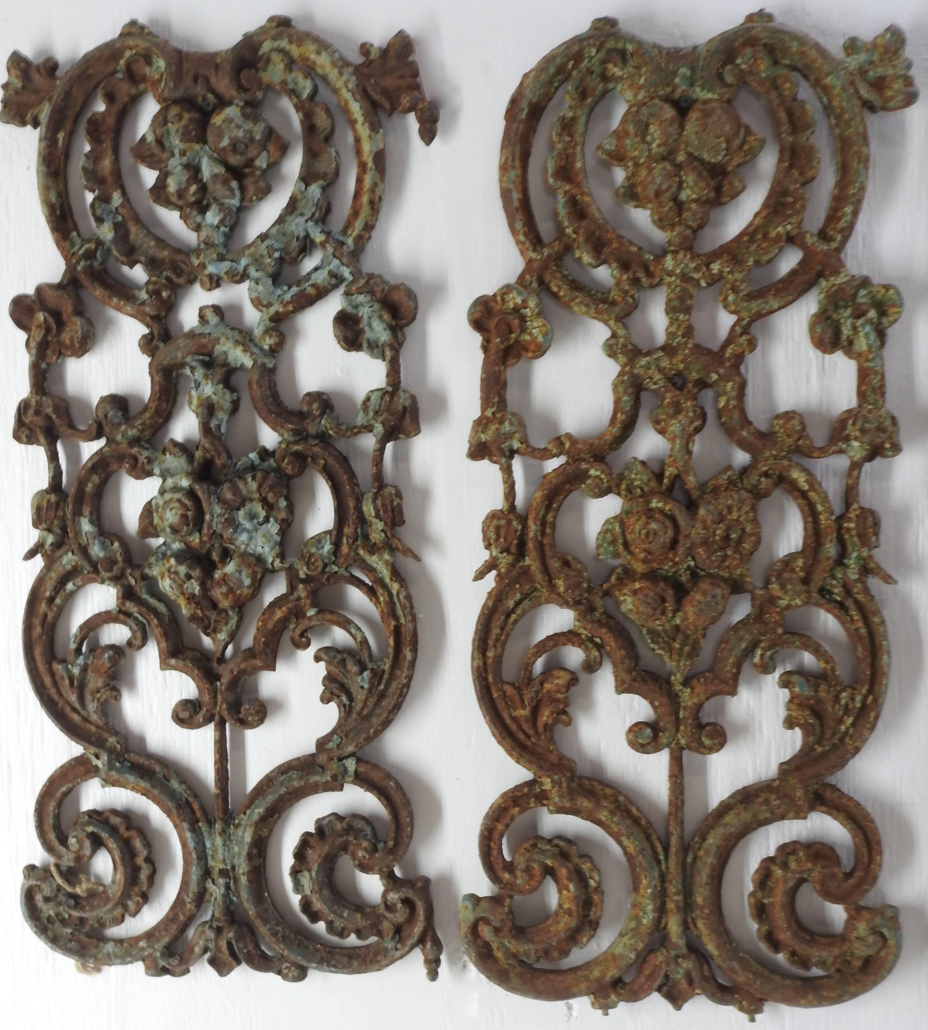 This is a nice set of wrought iron panels in the Victorian style. They feature swirls of metal with floral details. The panels have remains of turquoise paint to give them a rustic look.
  