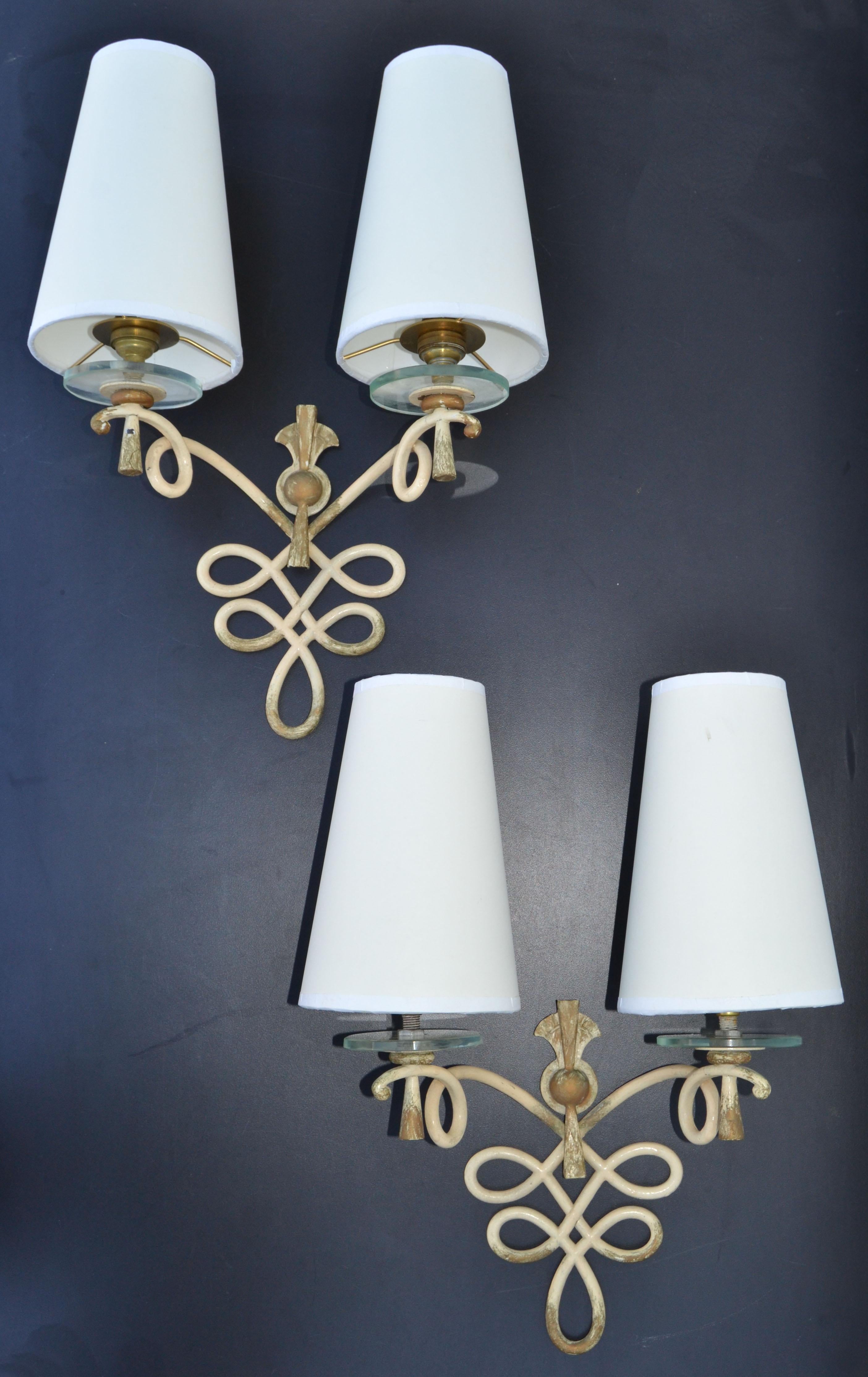 Superb pair of French Art Deco wrought iron with round glass discs sconces, wall lights with beige and gold finish,
They come with custom-made beige paper cone shades.
working condition each sconce takes 2 light bulbs with max. 40 watts, LED work