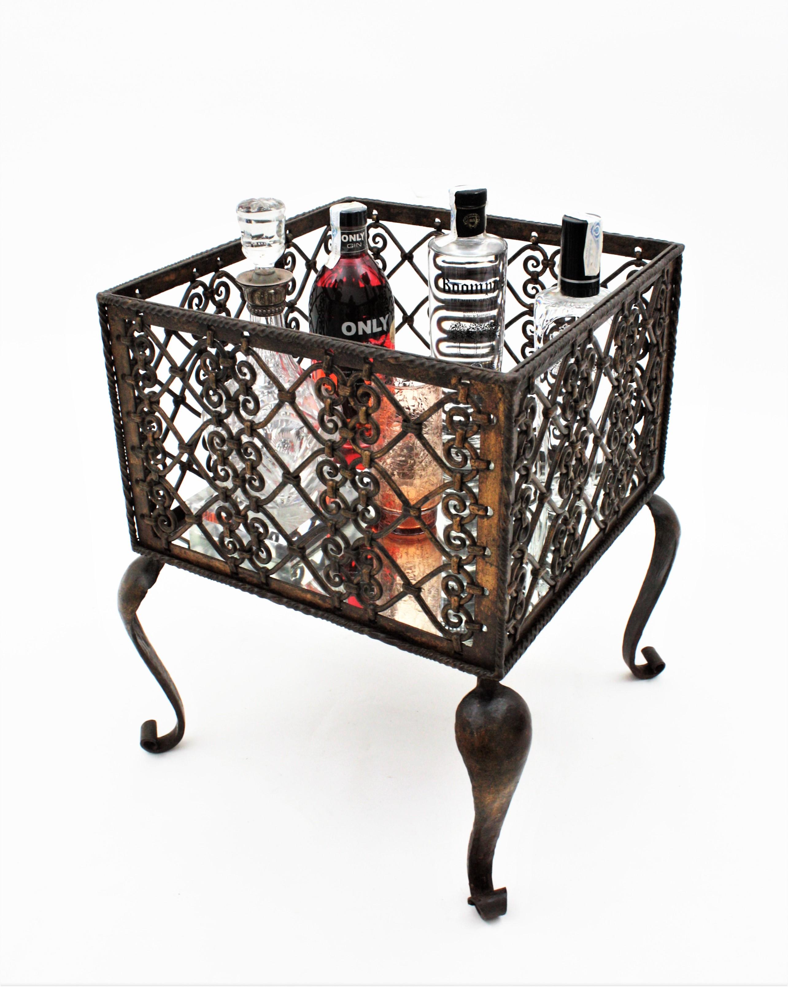 Image of Wrought iron planter with decorative scrollwork design