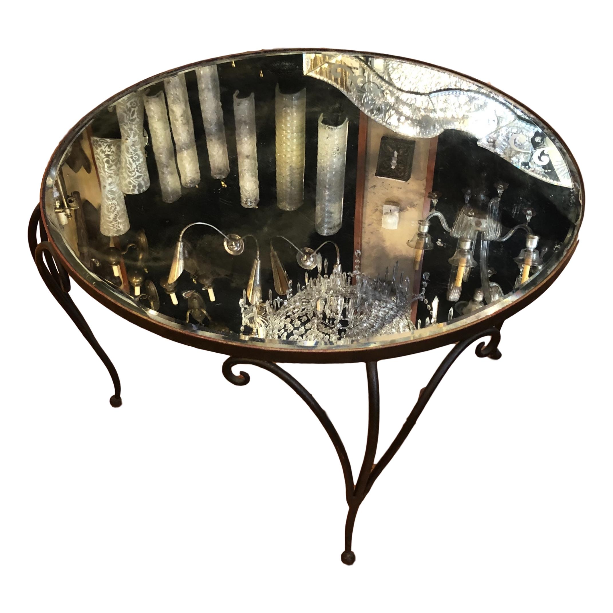 A circa 1930's French wrought iron coffee table with round mirror top.

Measurements:
Height: 18