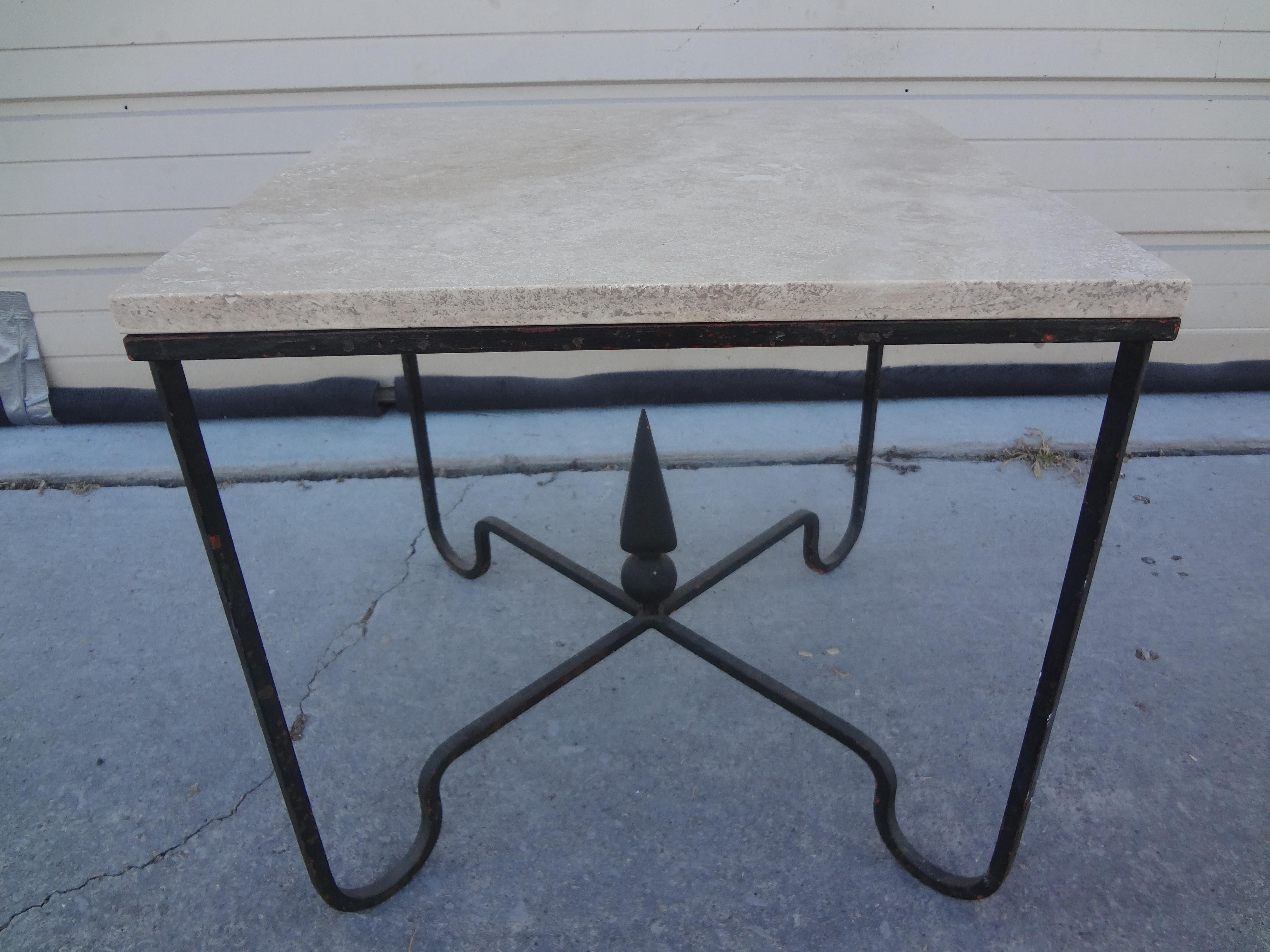 French wrought iron table with travertine top. This handsome French hand forged wrought iron table or side table has a beautiful travertine top and can be
placed in any decor.