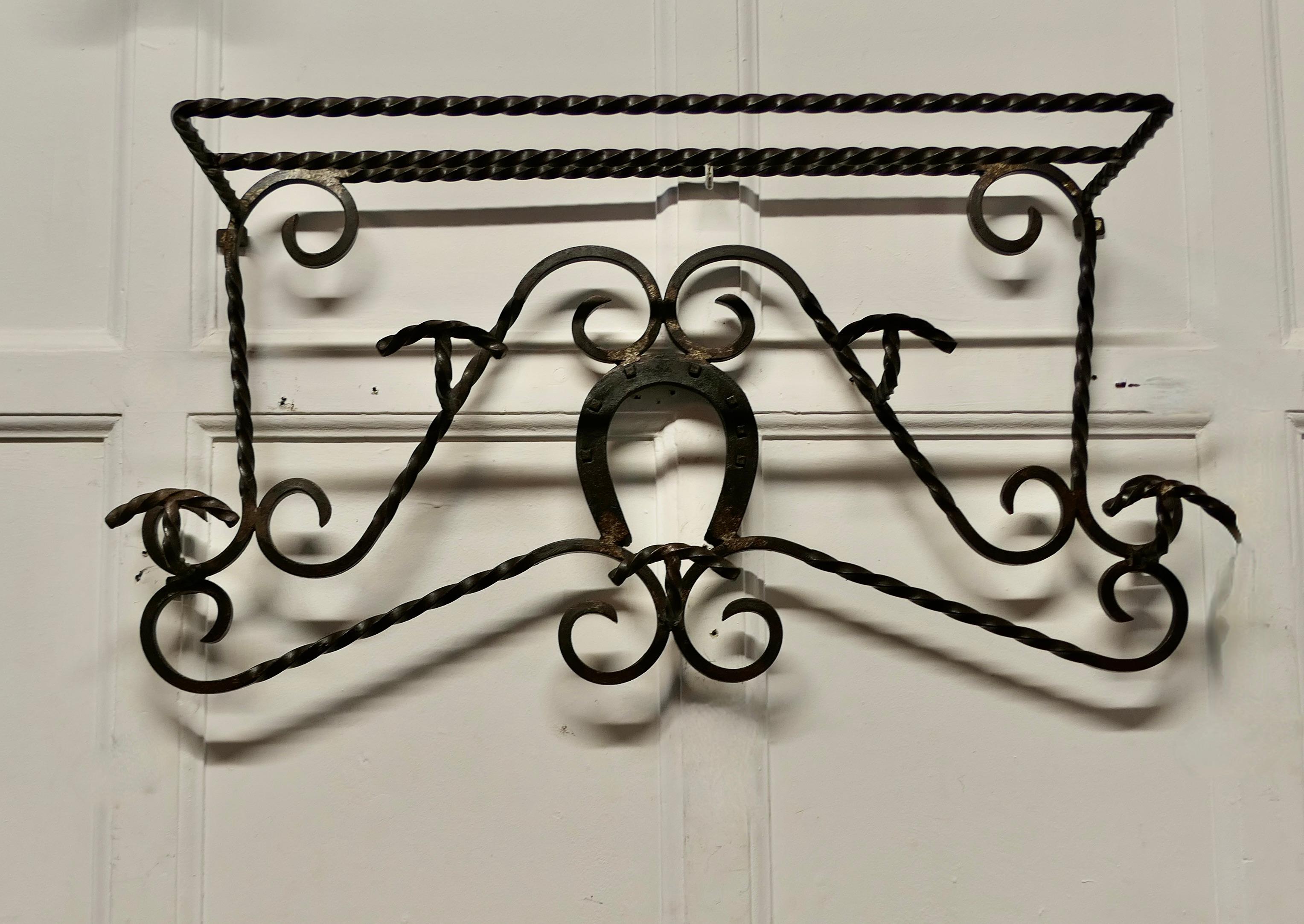 French Wrought Iron Wall Hanging Rack for Coats and Tack on a Horse Riding Theme 

This is an attractive wall hanging rack with 5 hangers and various other hooks, these are iron and at the centre there is a Horse shoe
A very attractive and useful