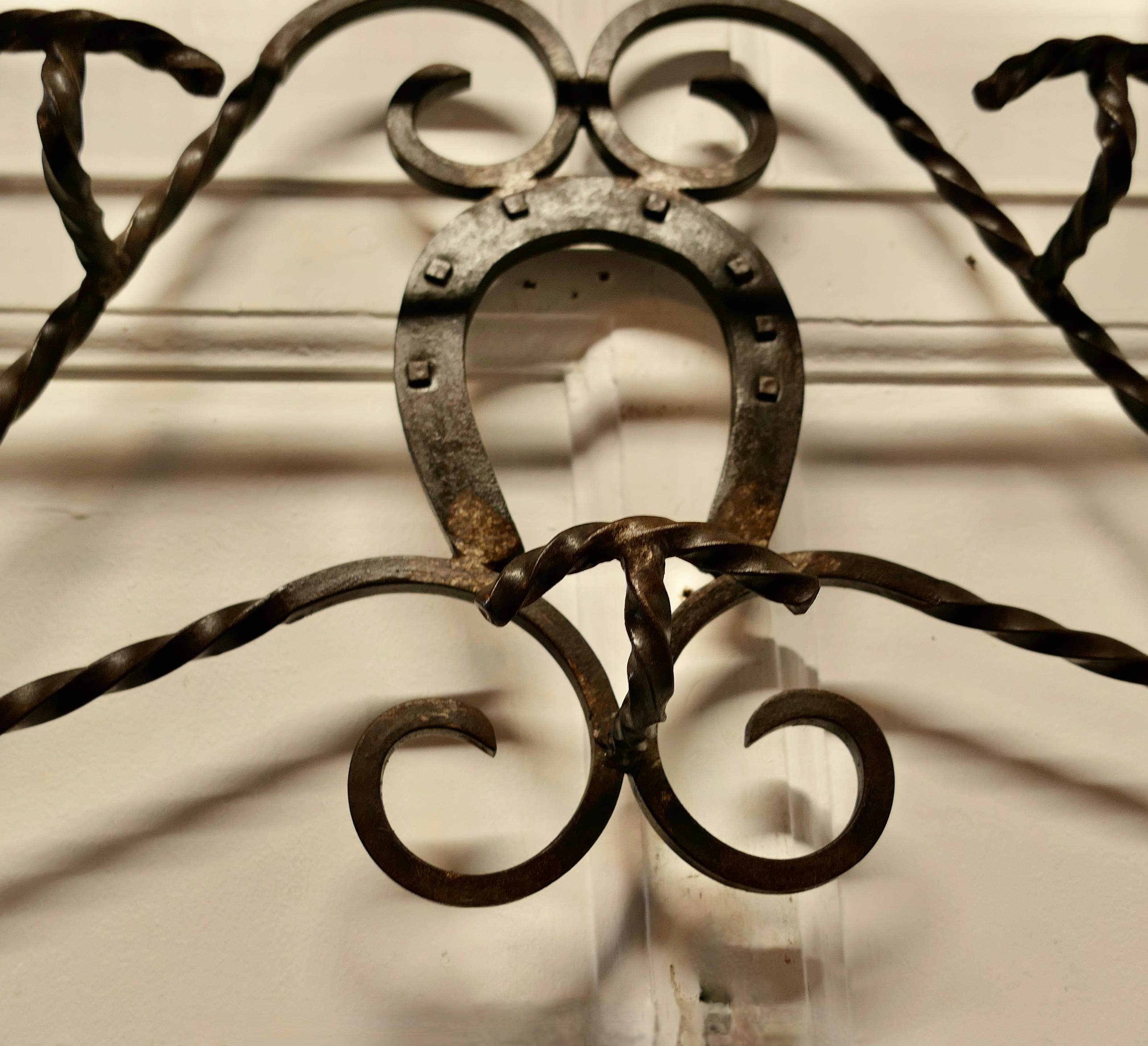 Early 20th Century French Wrought Iron Wall Hanging Rack for Coats and Tack on a Horse Riding Theme For Sale