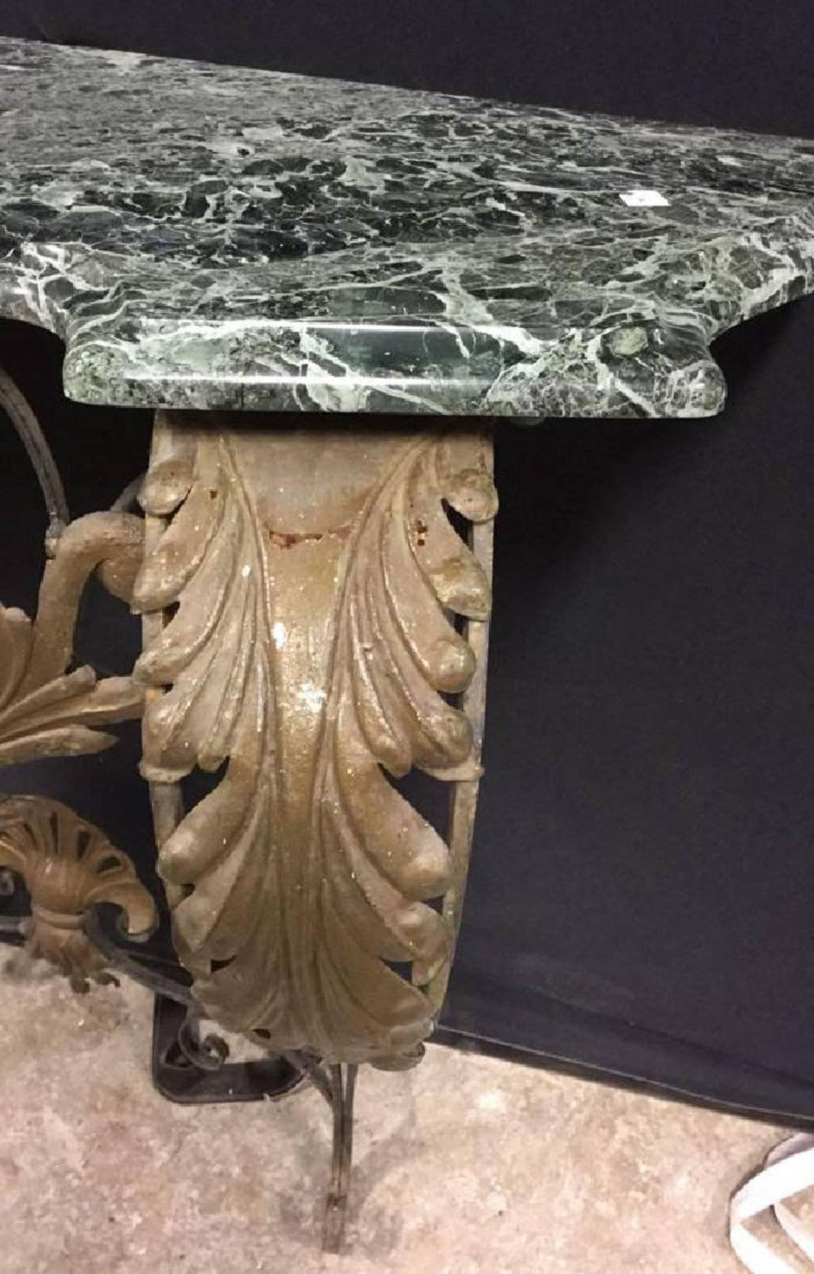 Rococo style console table made with wrought iron, gilt metal leaf decoration and green serpentine marble top on ornate metal base. Entry hallway table.
