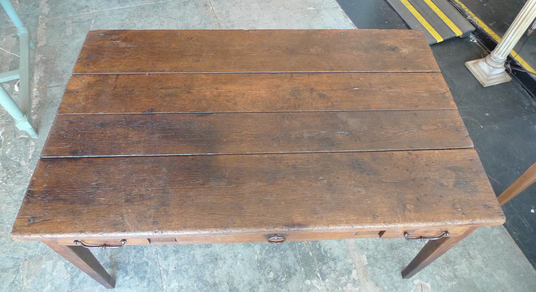 French 19th century stained walnut dining table or desk with 3 deep drawers and original iron hardware. 